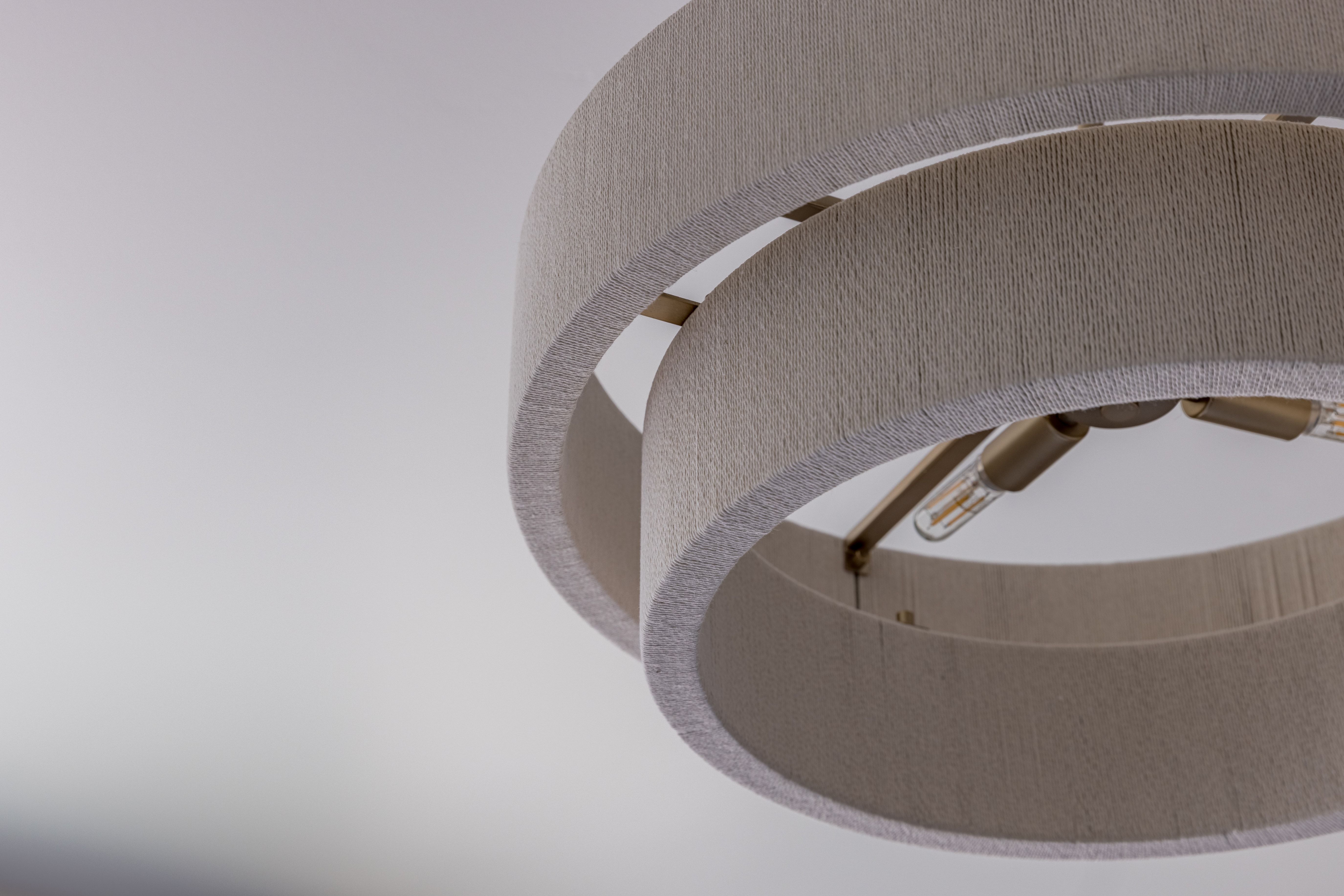 Multi-tiered fabric drum chandelier with exposed Edison-style bulbs