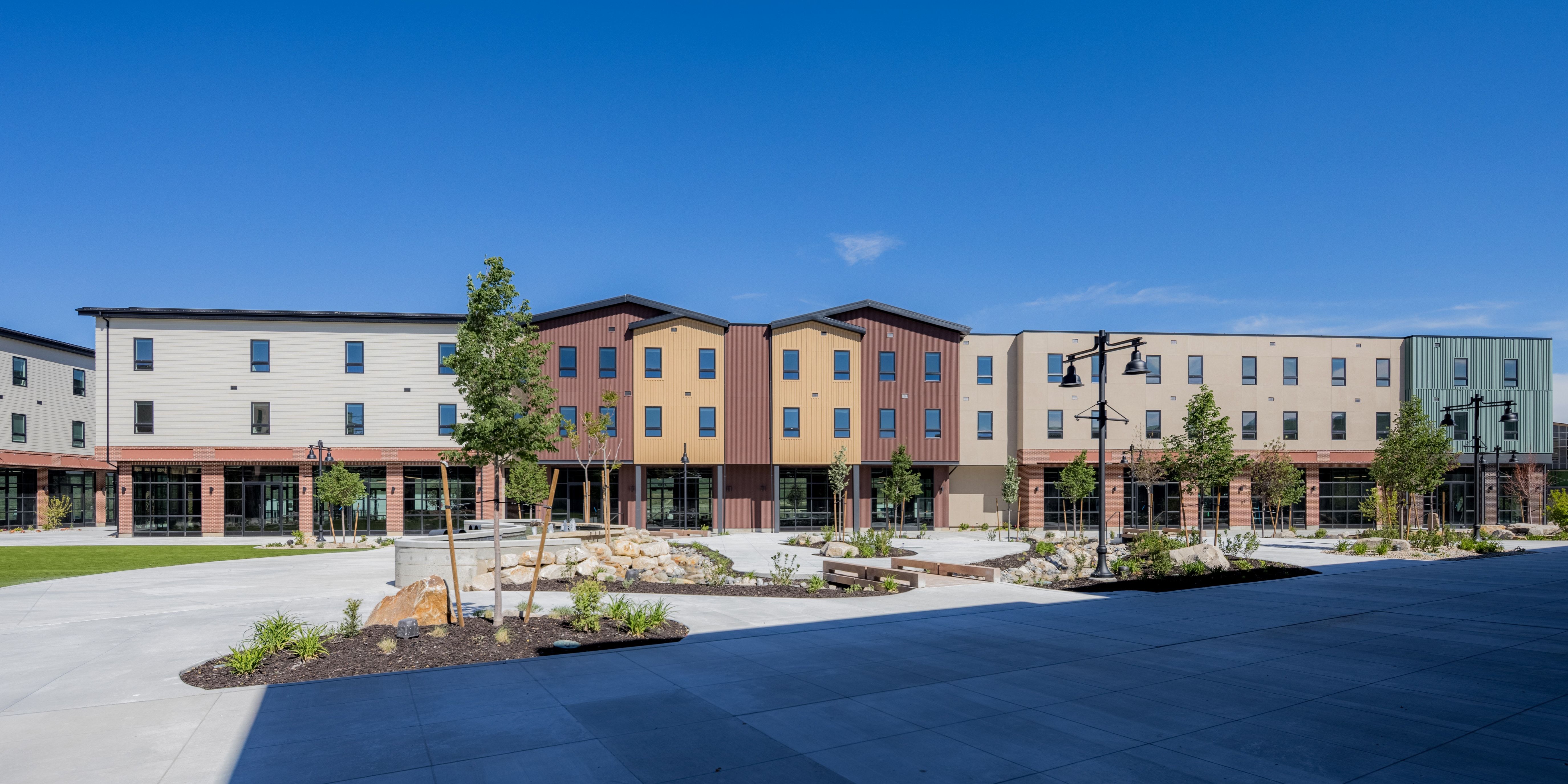 Modern multi-story buildings featuring varied facade colors and lower-level commercial spaces
