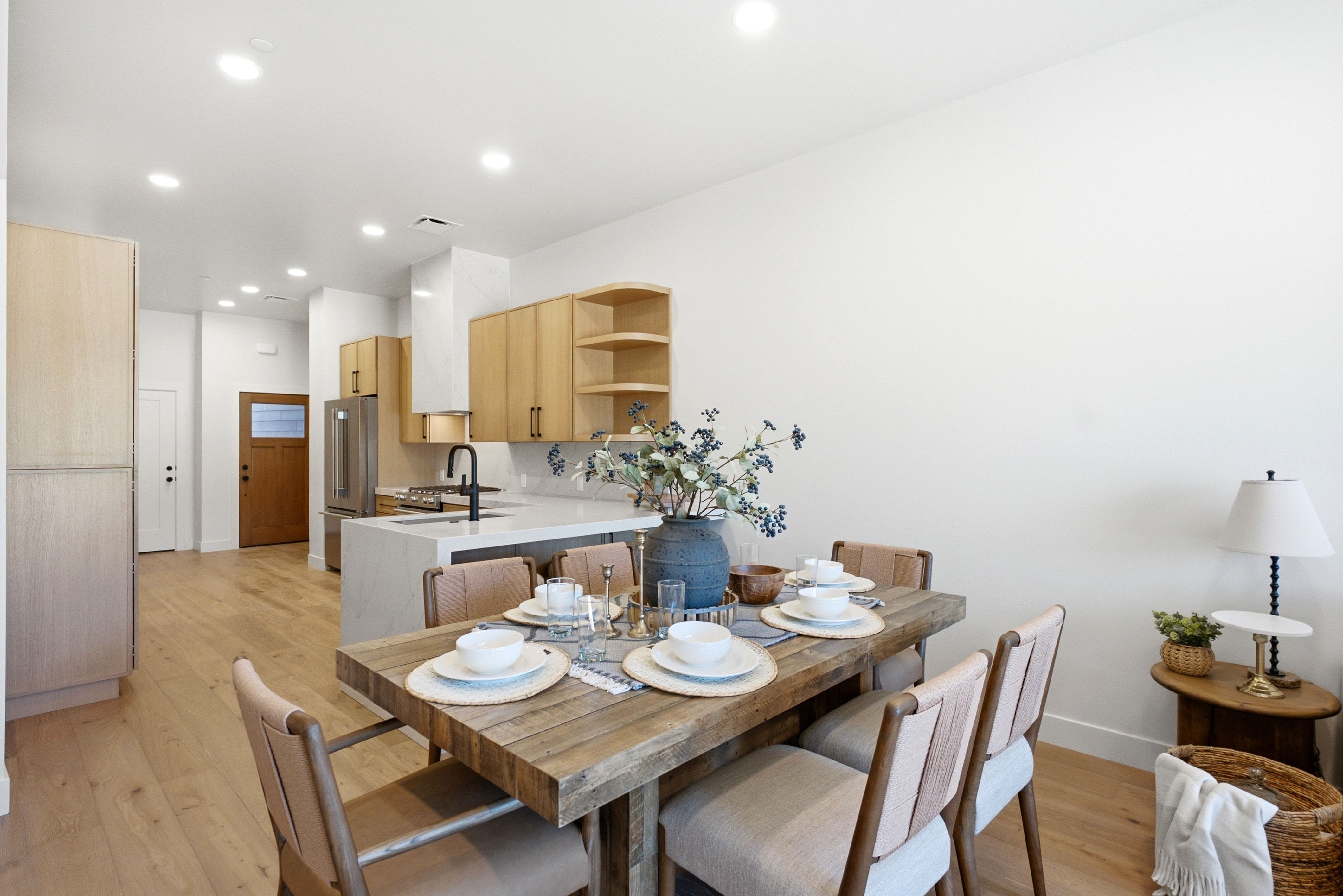 Open-concept living space with light wood-finish flooring