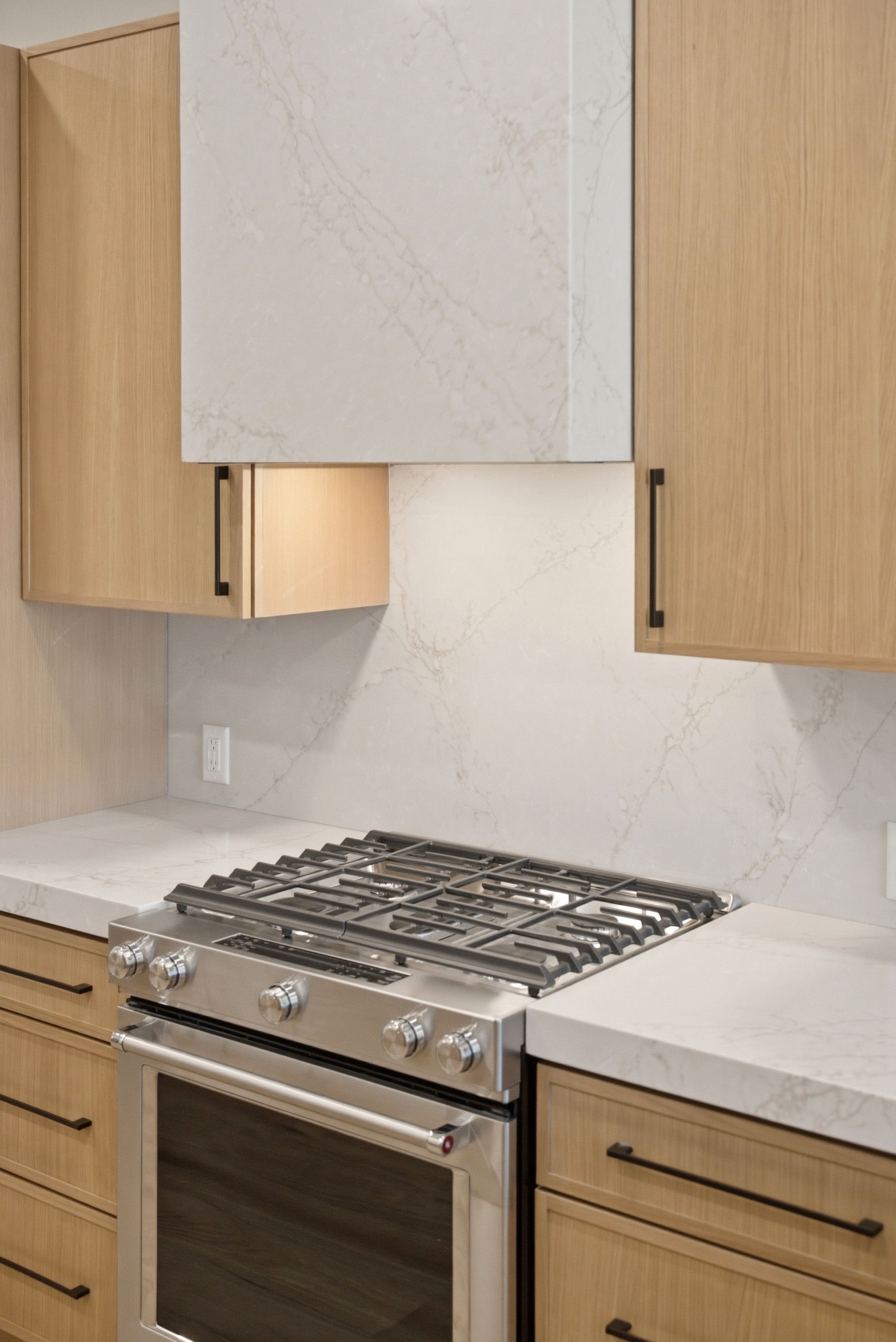 Stainless steel range and oven with a coordinating range hood