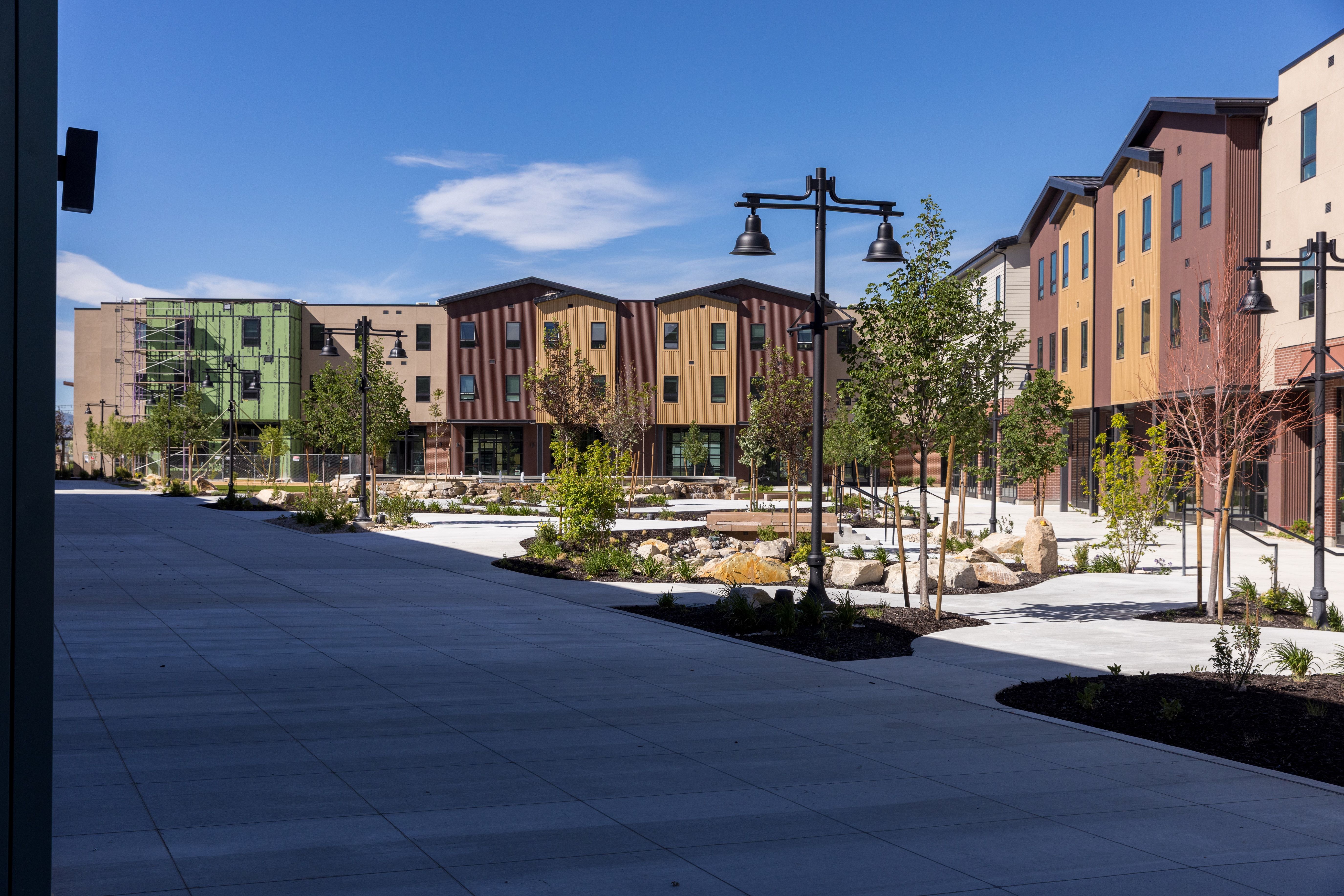 Outdoor courtyard featuring paved walkways, mature landscaping, and decorative streetlights