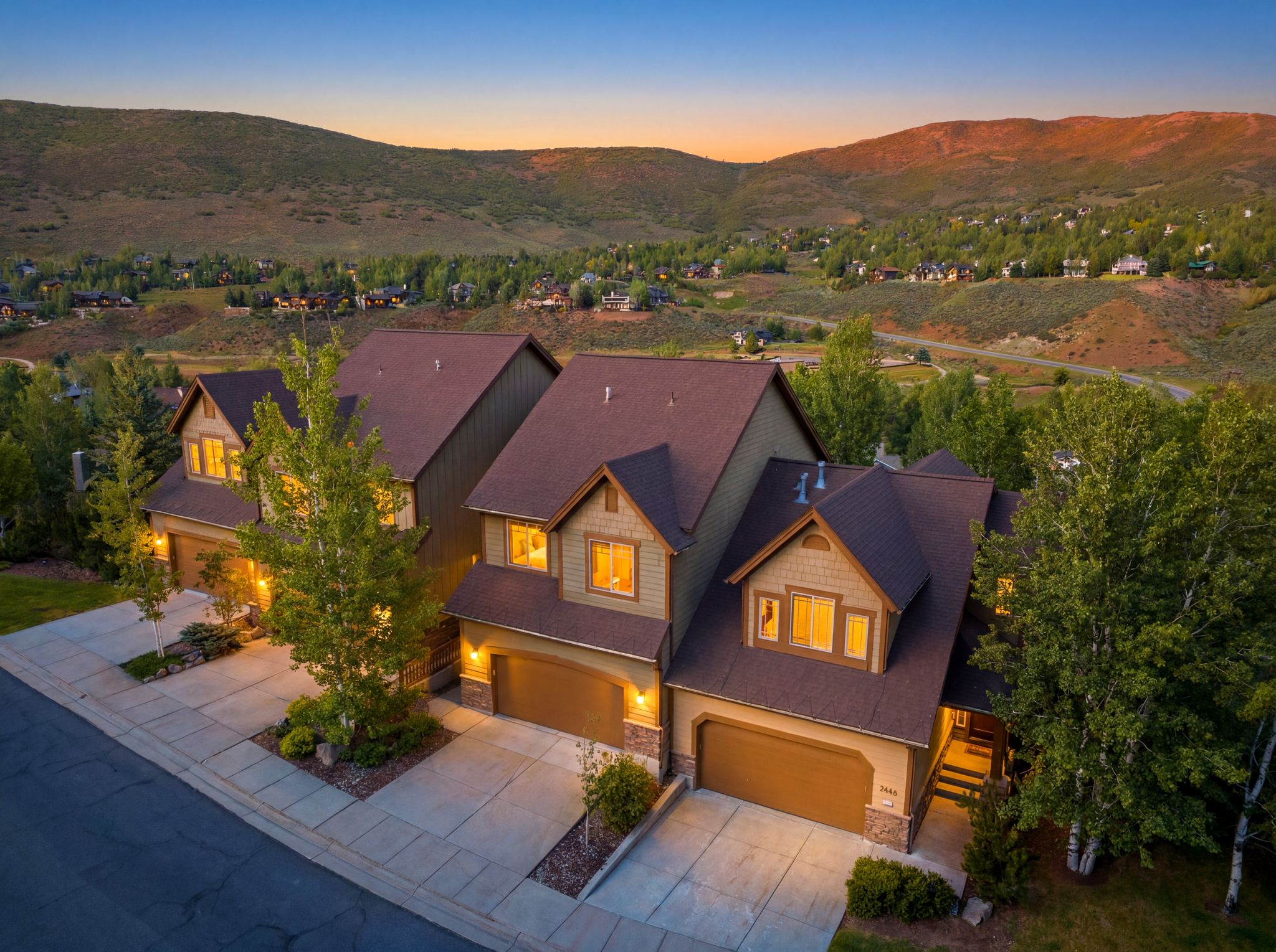 Attached multi-level residences featuring warm exterior siding and stone accents