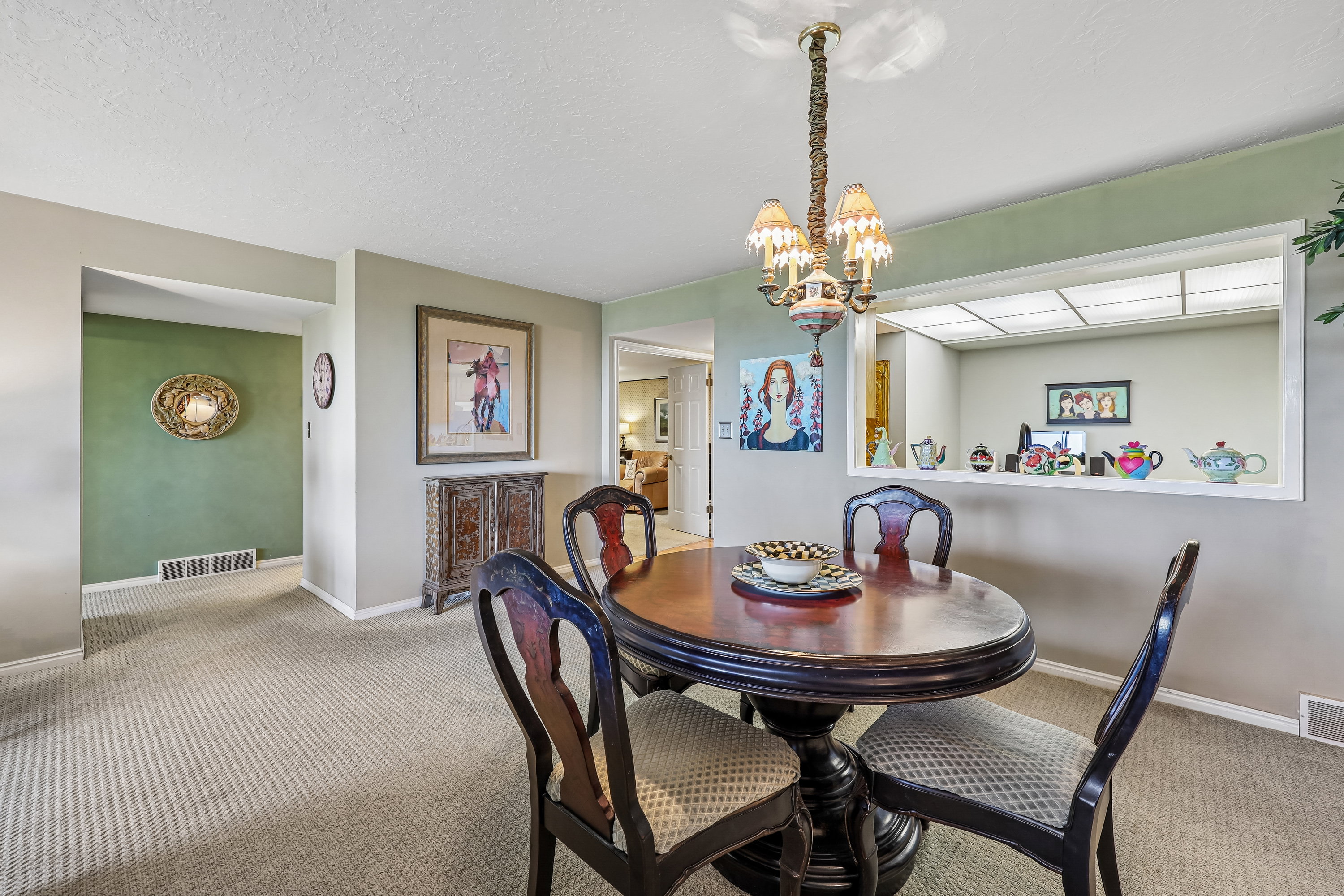 Defined dining area featuring a decorative chandelier with multiple shaded lights