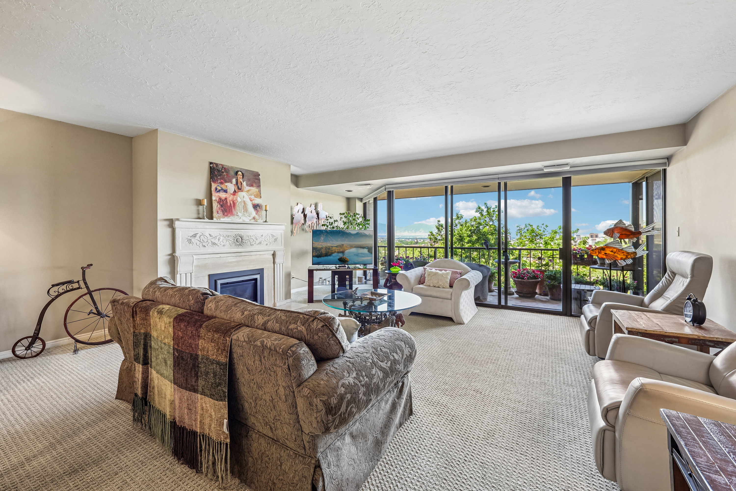 Living area featuring wall-to-wall carpeting, a decorative fireplace with an ornate mantelpiece, and neutral-toned walls