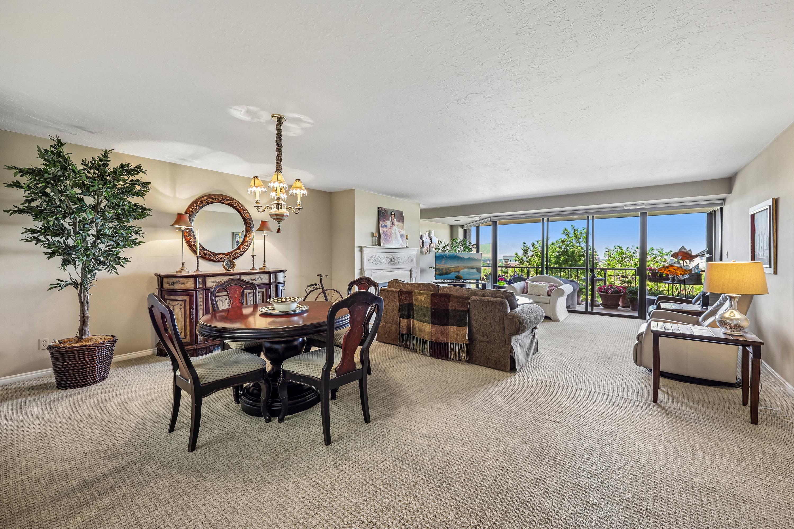 Open concept living and dining area featuring a full wall of glass doors opening to an exterior balcony