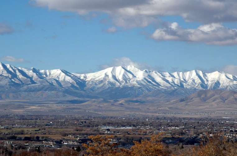 Expansive landscape featuring snow-capped mountain peaks in the distance