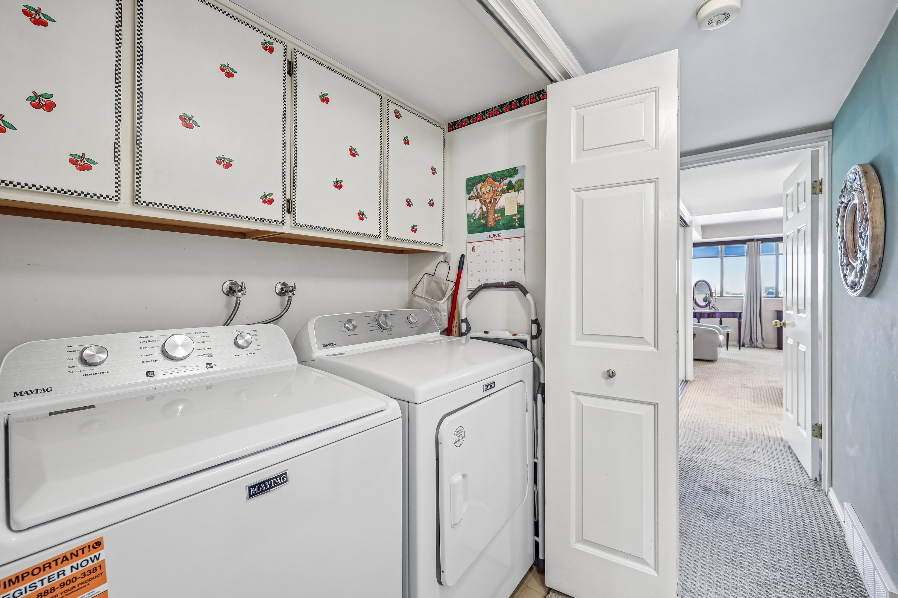 Dedicated laundry area featuring upper cabinetry for storage