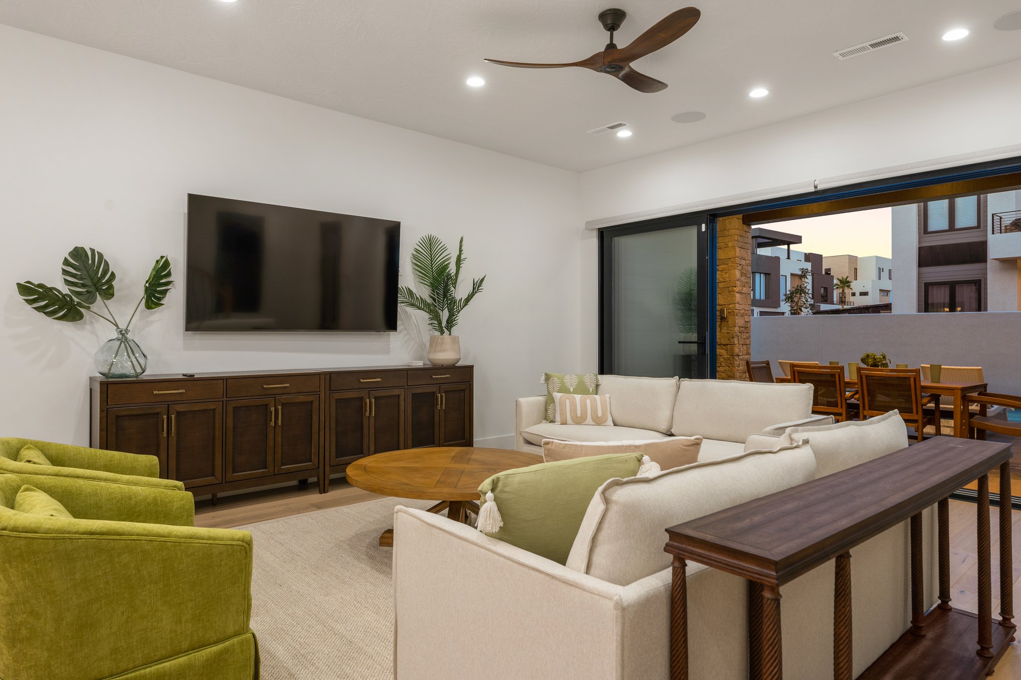 Expansive living area featuring recessed lighting, a modern ceiling fan, and large format sliding glass doors