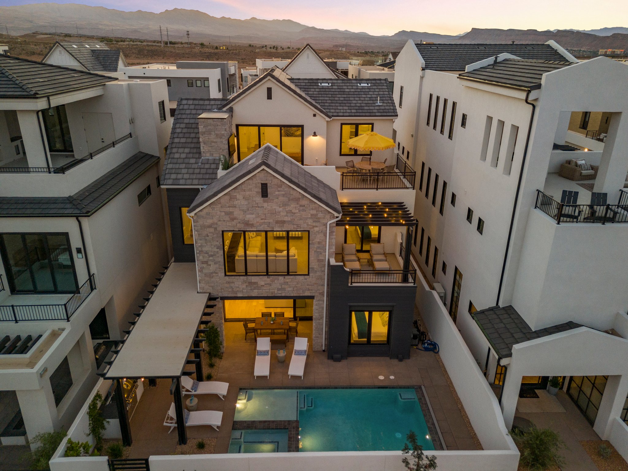 Modern multi-level residence featuring a private pool, multiple outdoor patios, and a rooftop terrace