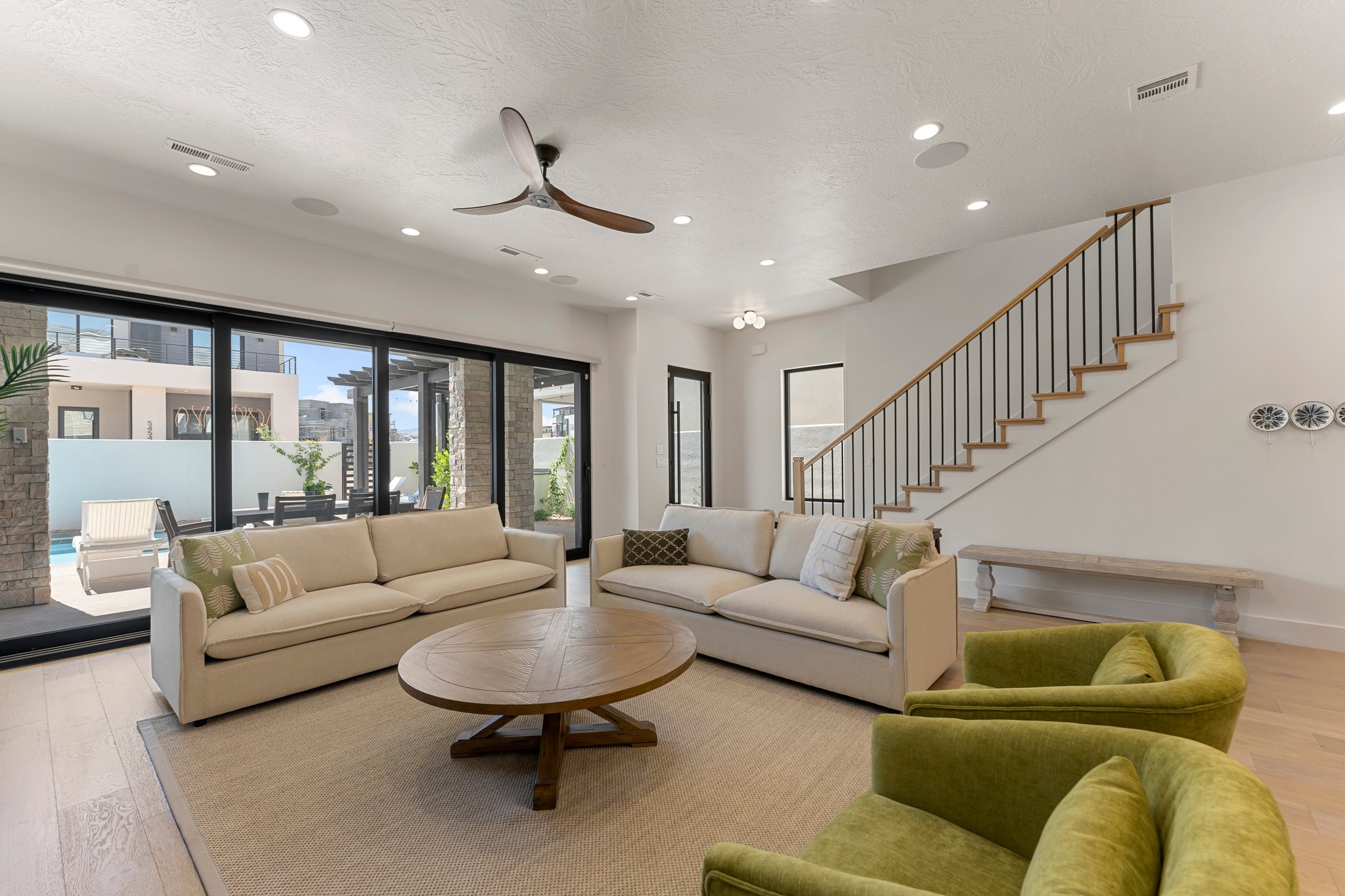 Open concept living area featuring wood-finish flooring, recessed lighting, and a modern ceiling fan