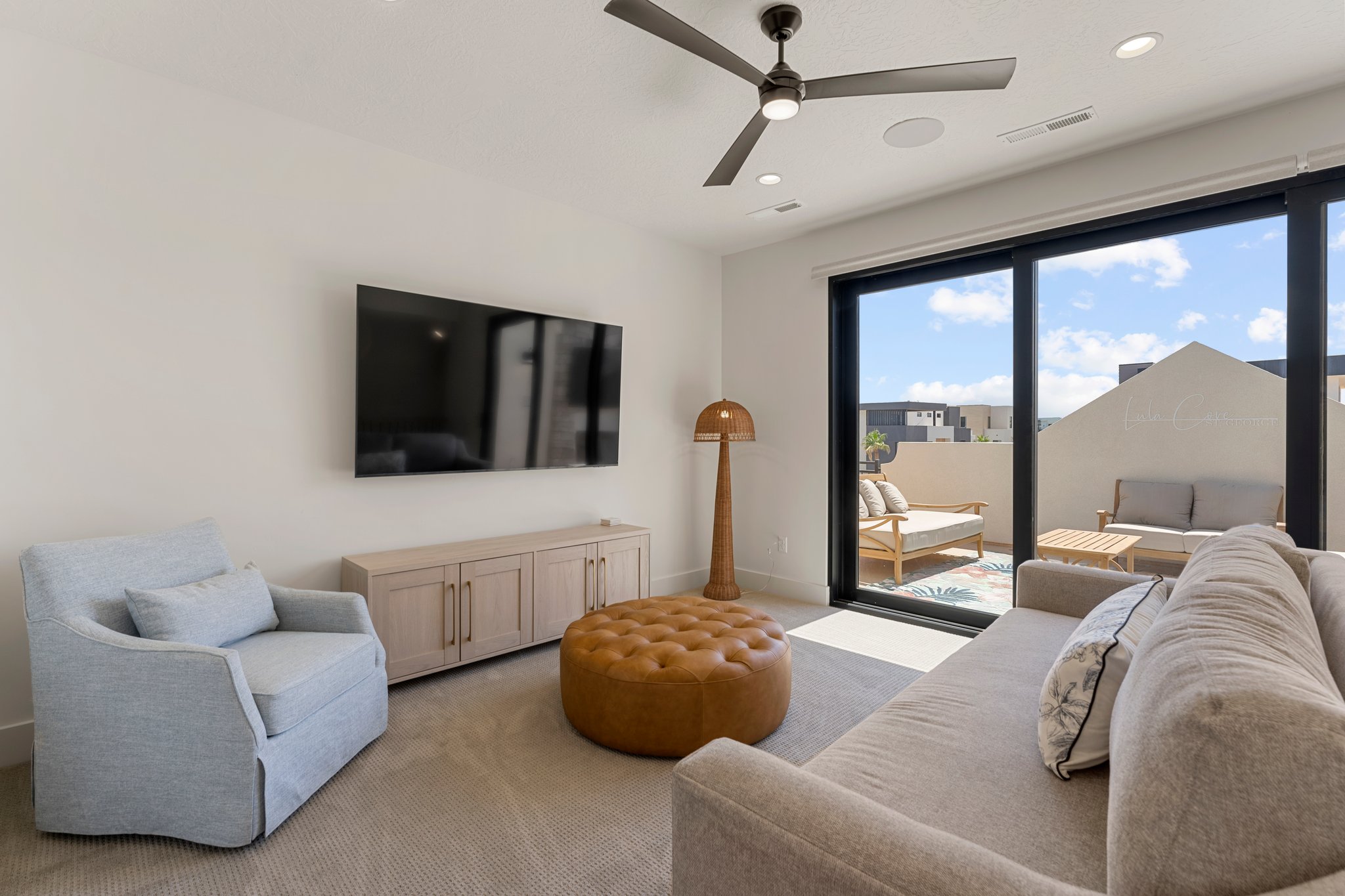 Expansive sliding glass doors open to a private outdoor patio