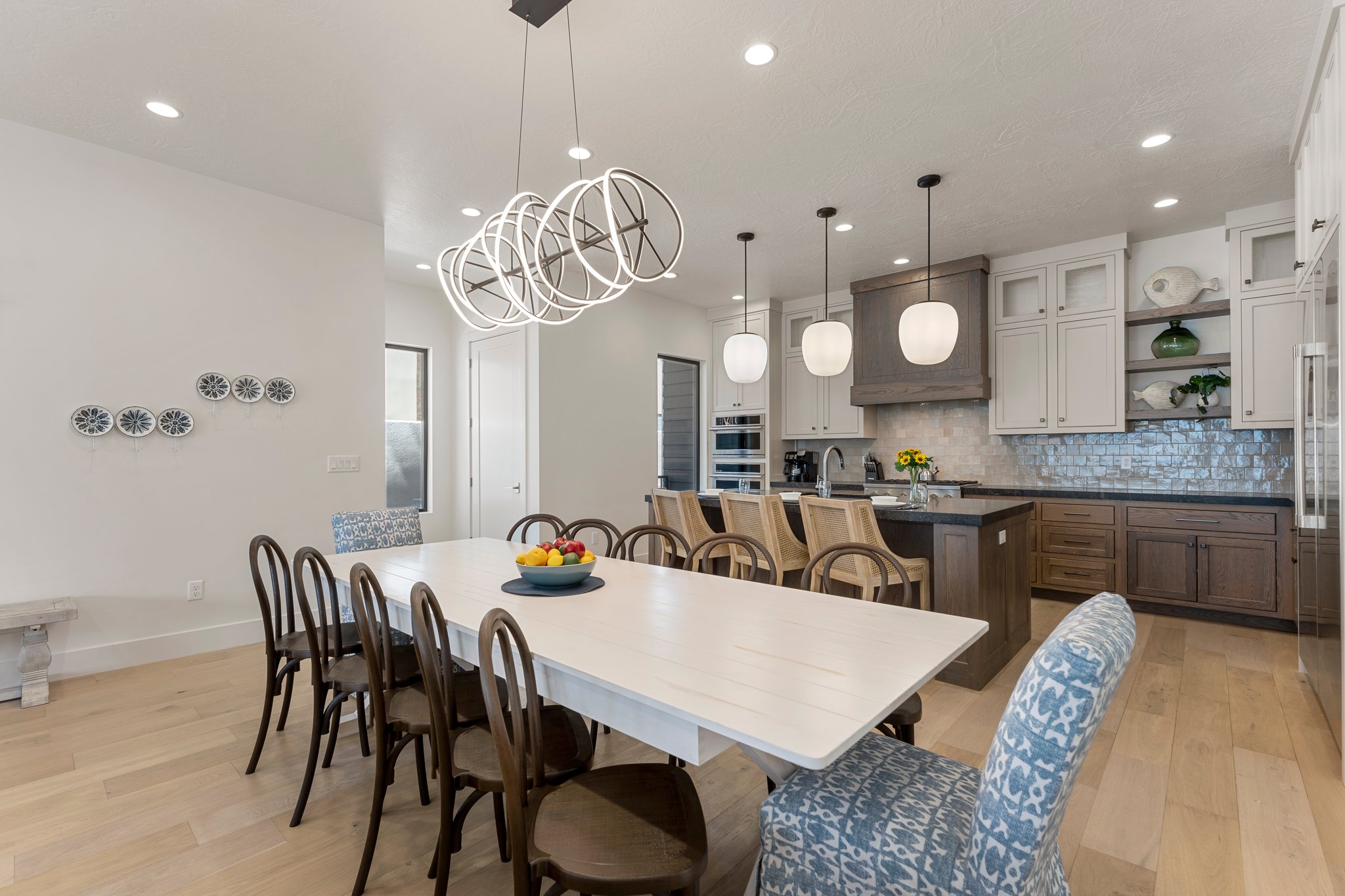 Open-concept kitchen and dining area featuring light wood-finish flooring