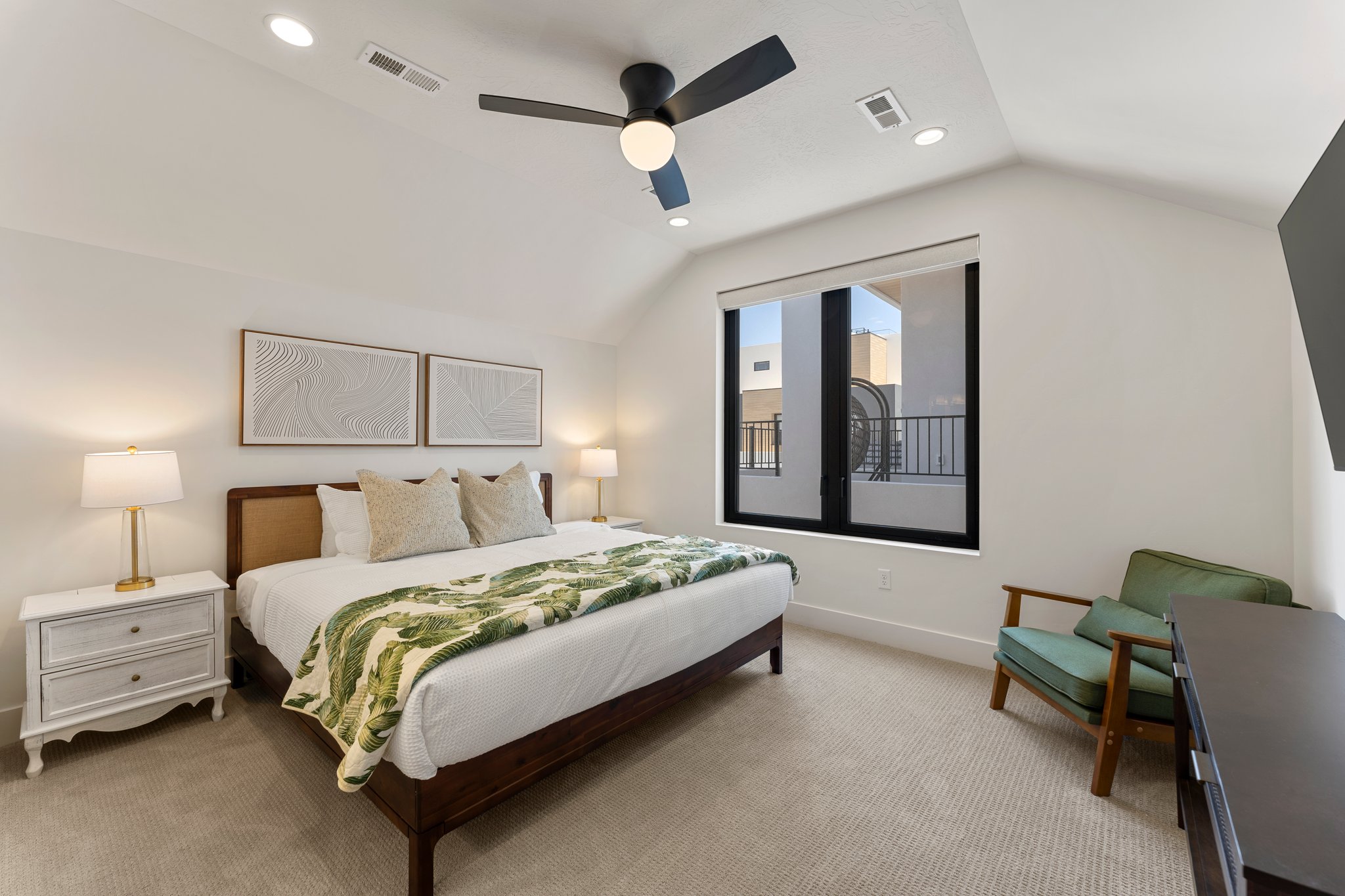 Carpeted room featuring a ceiling fan with integrated lighting, recessed lighting, and a large window with black framing
