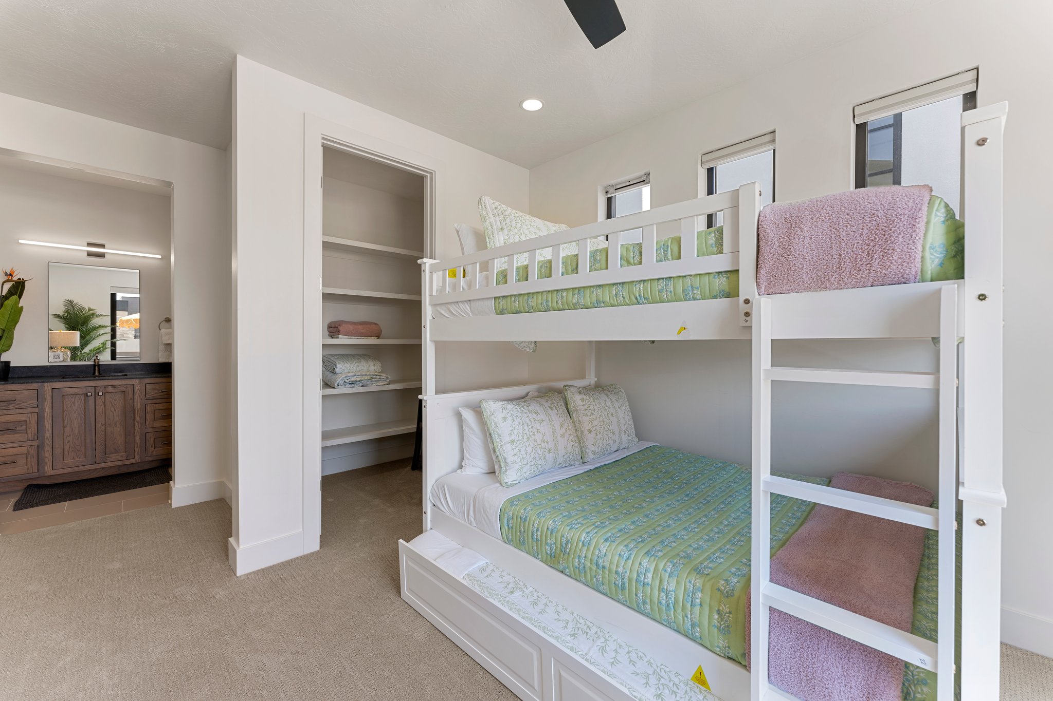 Light-filled room featuring built-in bunk beds, recessed lighting, and a ceiling fan