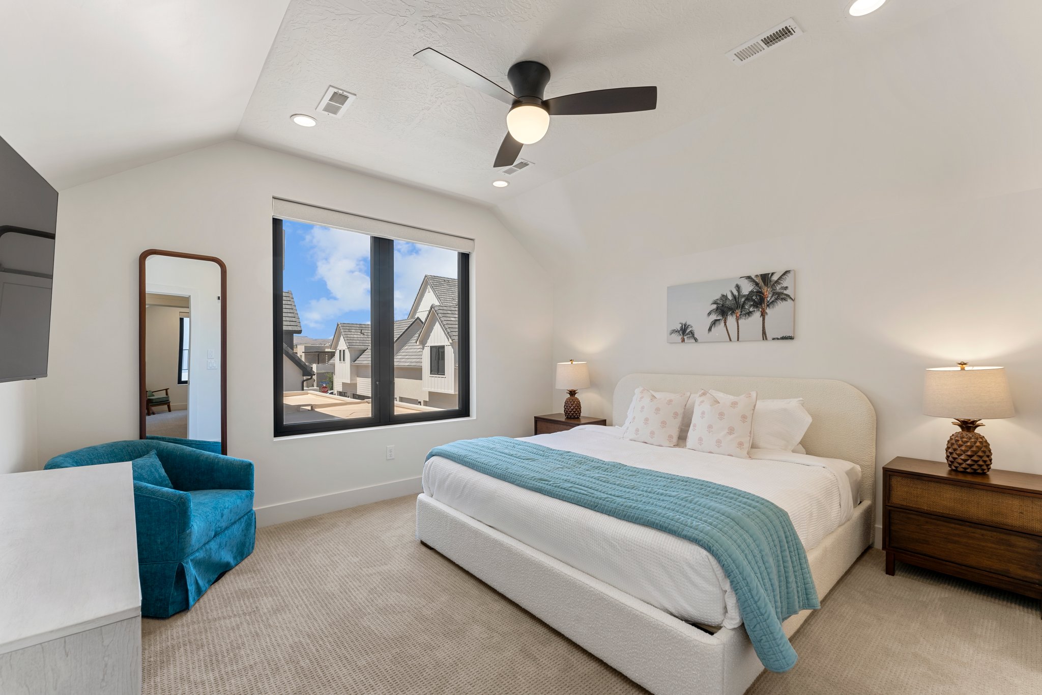 Vaulted ceilings featuring recessed lighting and a ceiling fan, large window with black trim, and light-toned carpet flooring