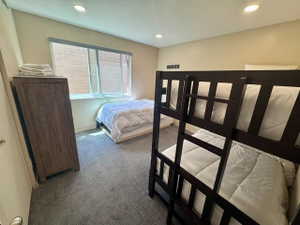 Carpeted room featuring recessed lighting and a window with blinds