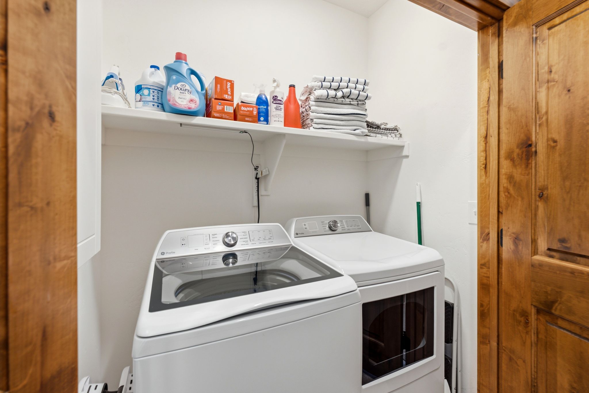 Dedicated laundry area featuring a white top-load washer and front-load dryer
