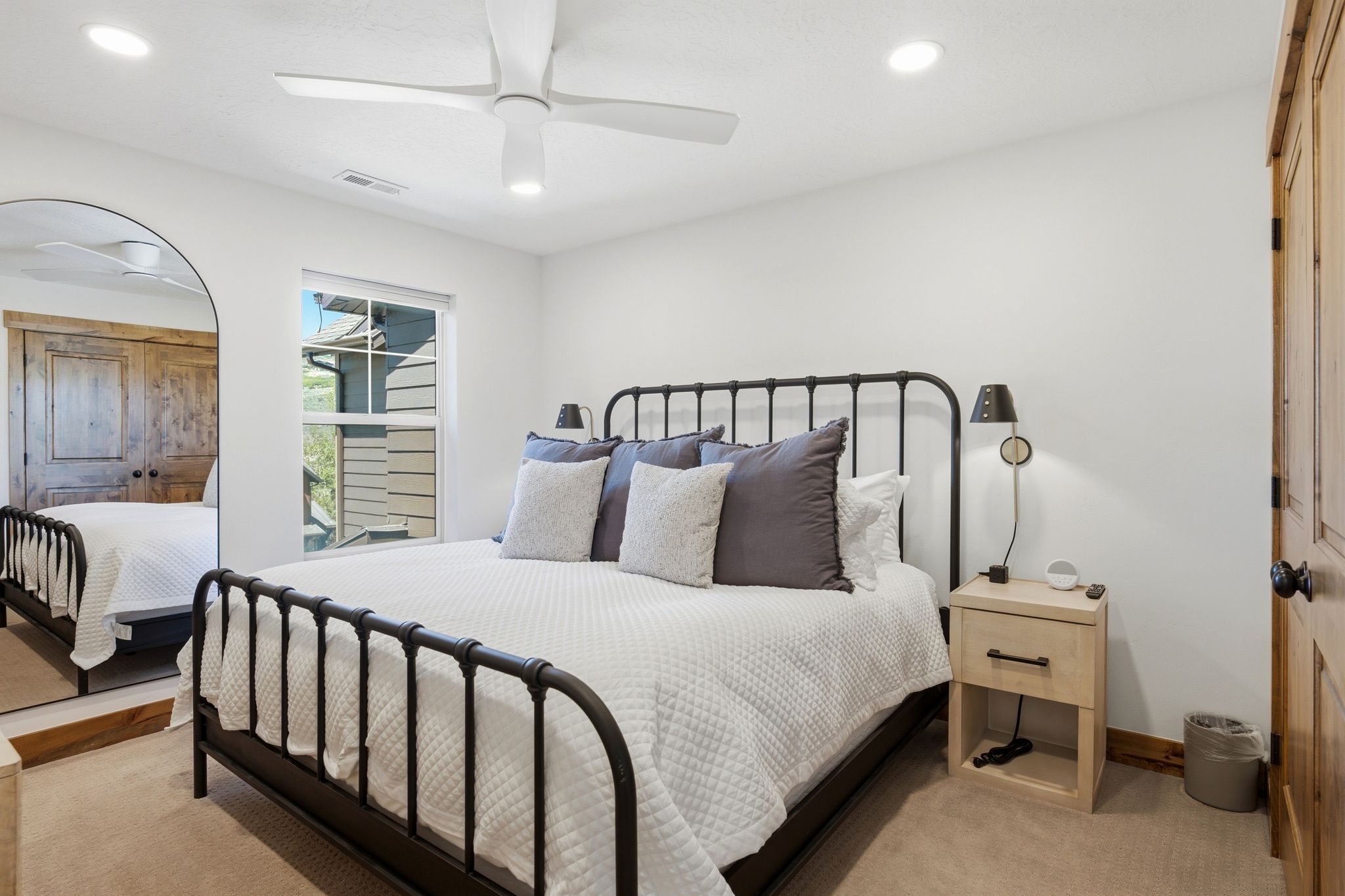 Carpeted room featuring a window, recessed lighting, and a ceiling fan