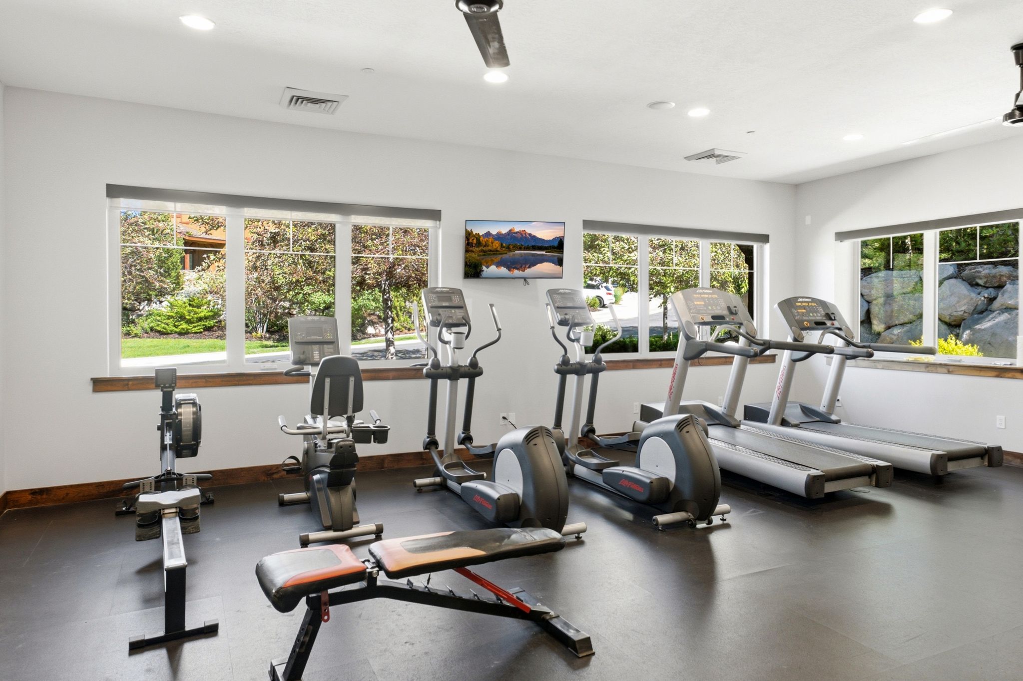 Dedicated fitness room featuring recessed lighting and multiple large windows