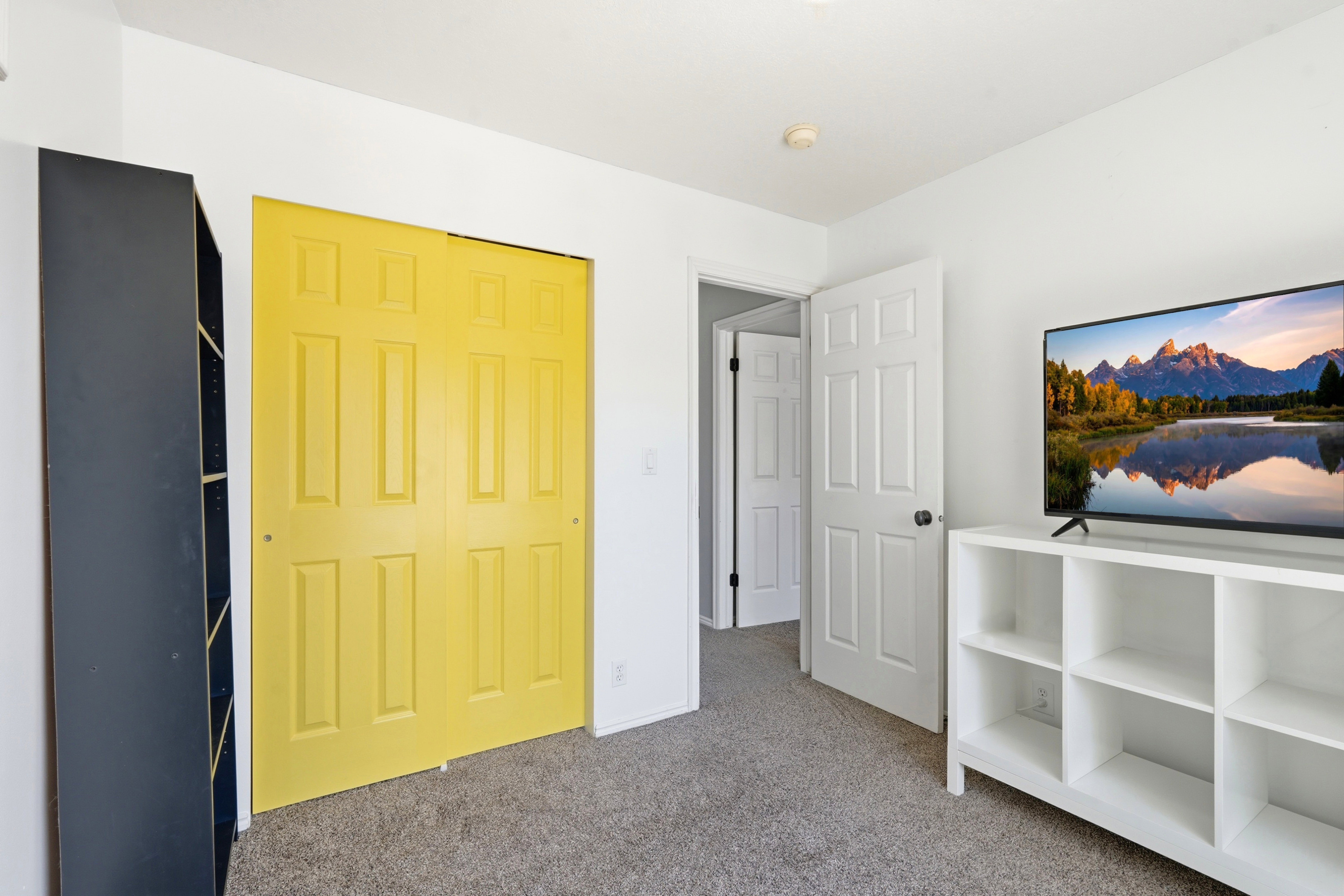 Interior room featuring light gray carpeting and white walls