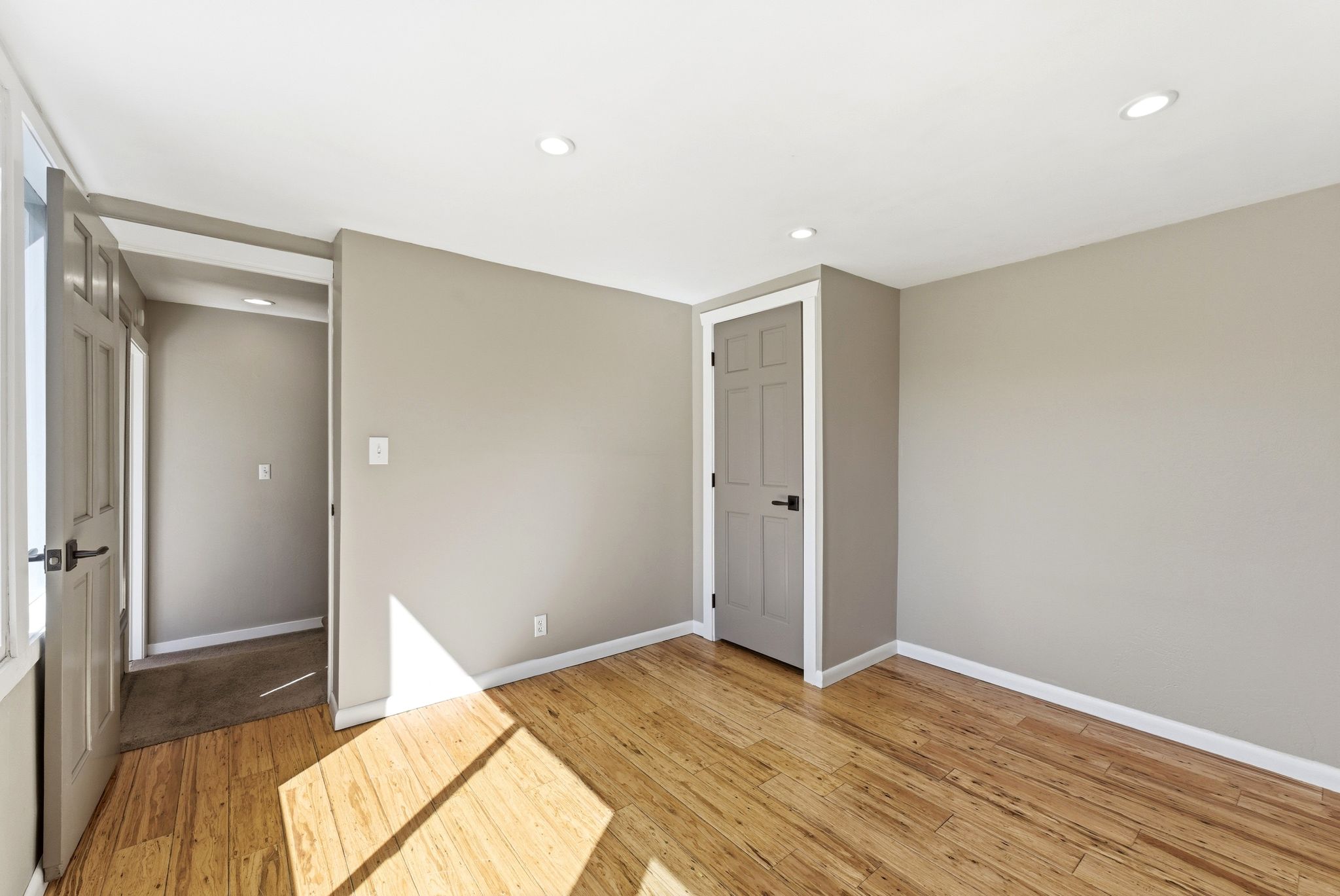 Room featuring wood-finish flooring, recessed lighting, and neutral wall tones