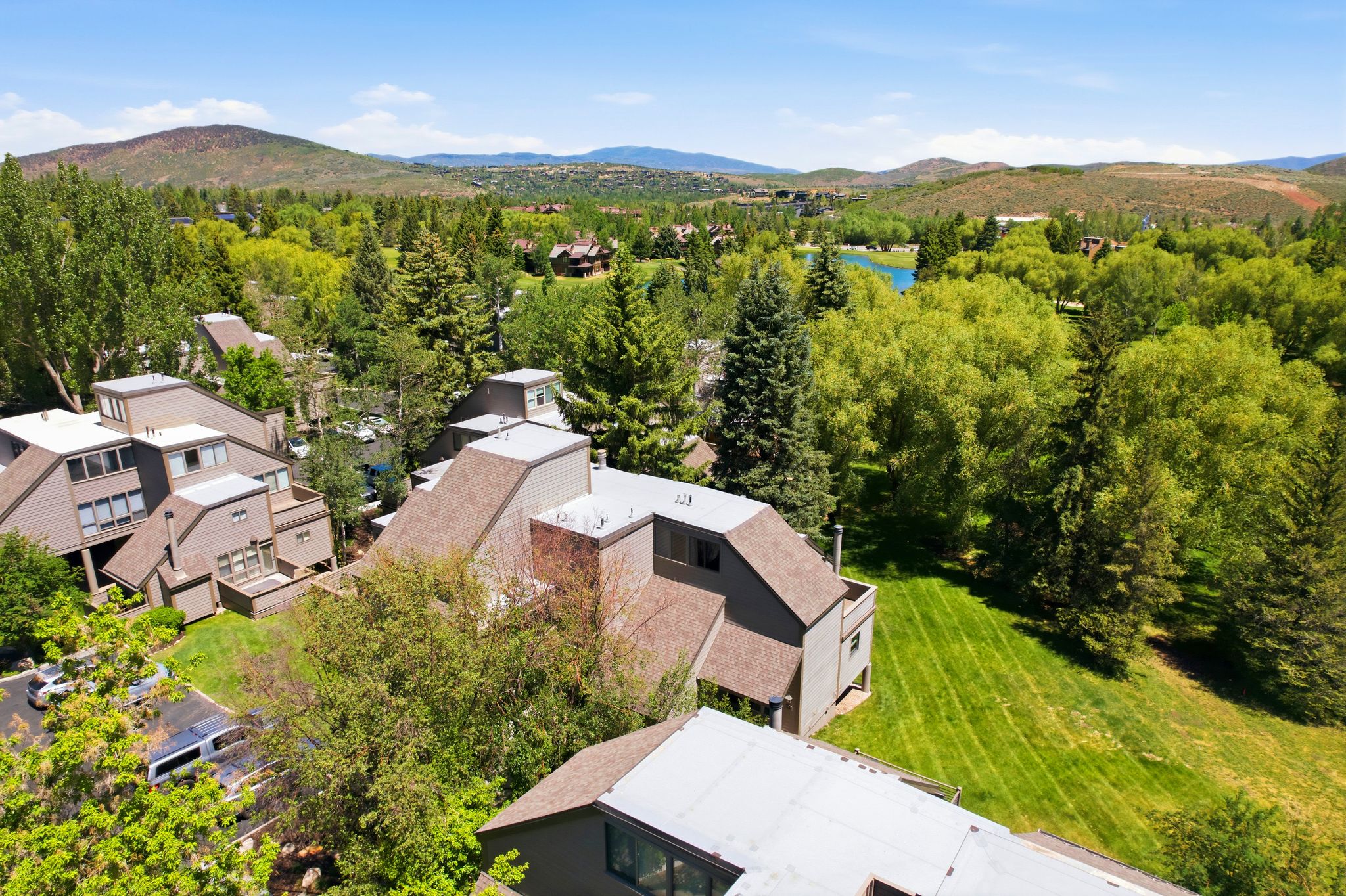Contemporary multi-story architecture with sloped roofs and light-colored siding