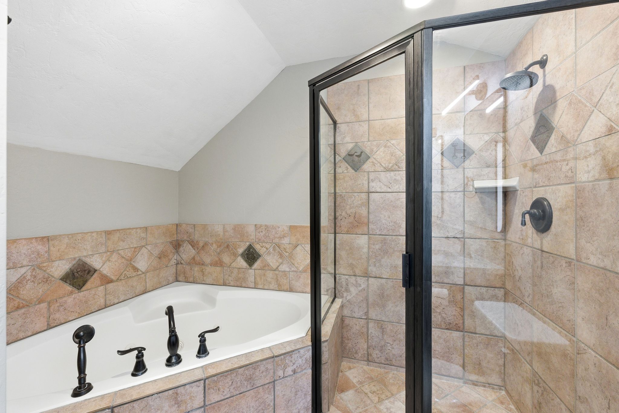 Corner soaking tub with dark bronze fixtures