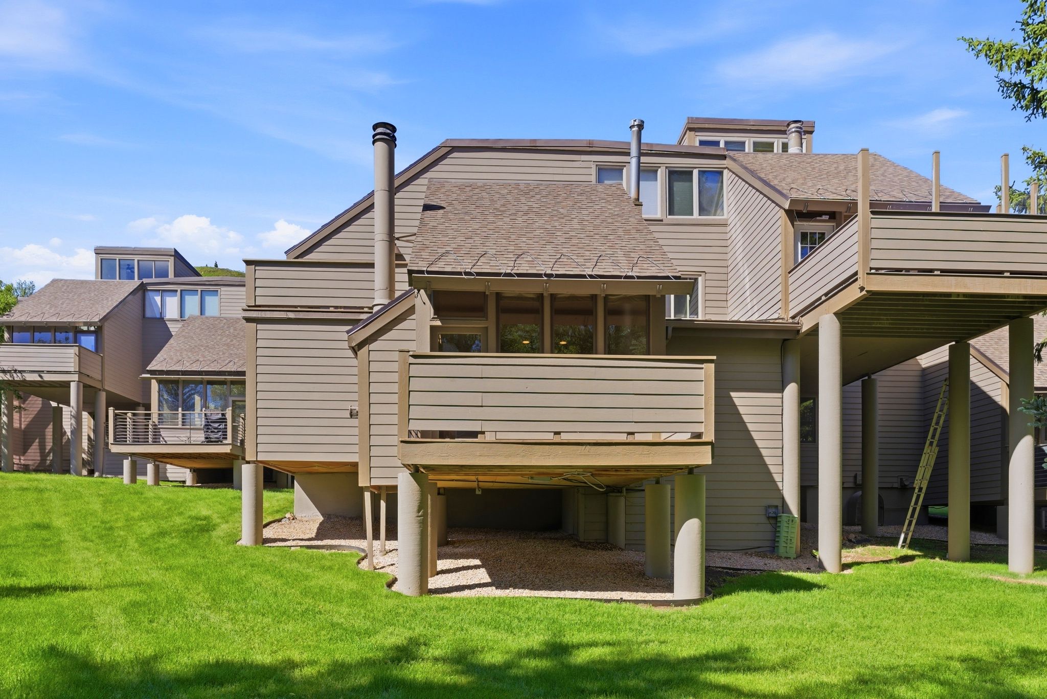 Multi-level exterior with horizontal siding and multiple private balconies