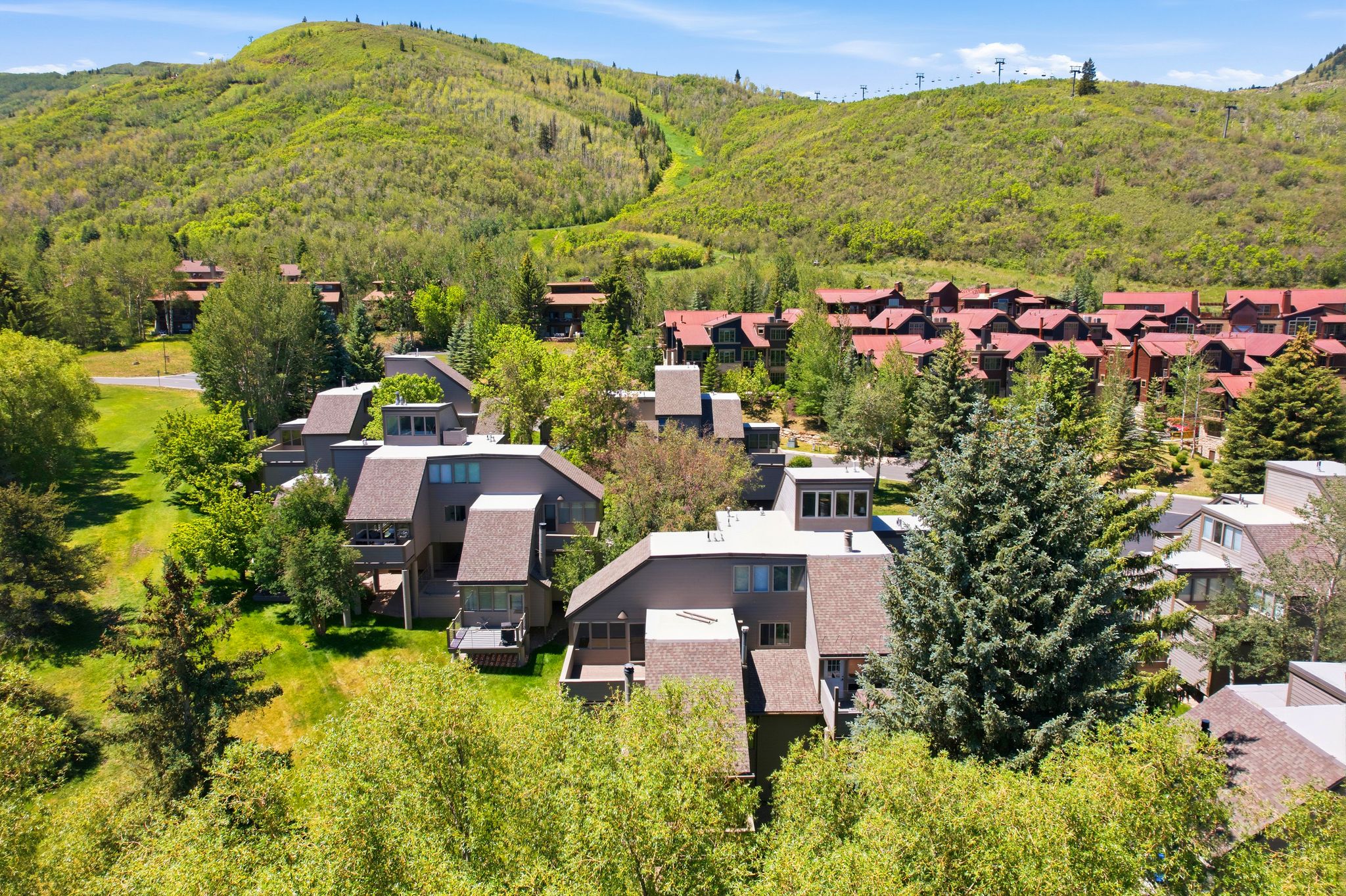 Multi-level property featuring sloped roofs and multiple balconies