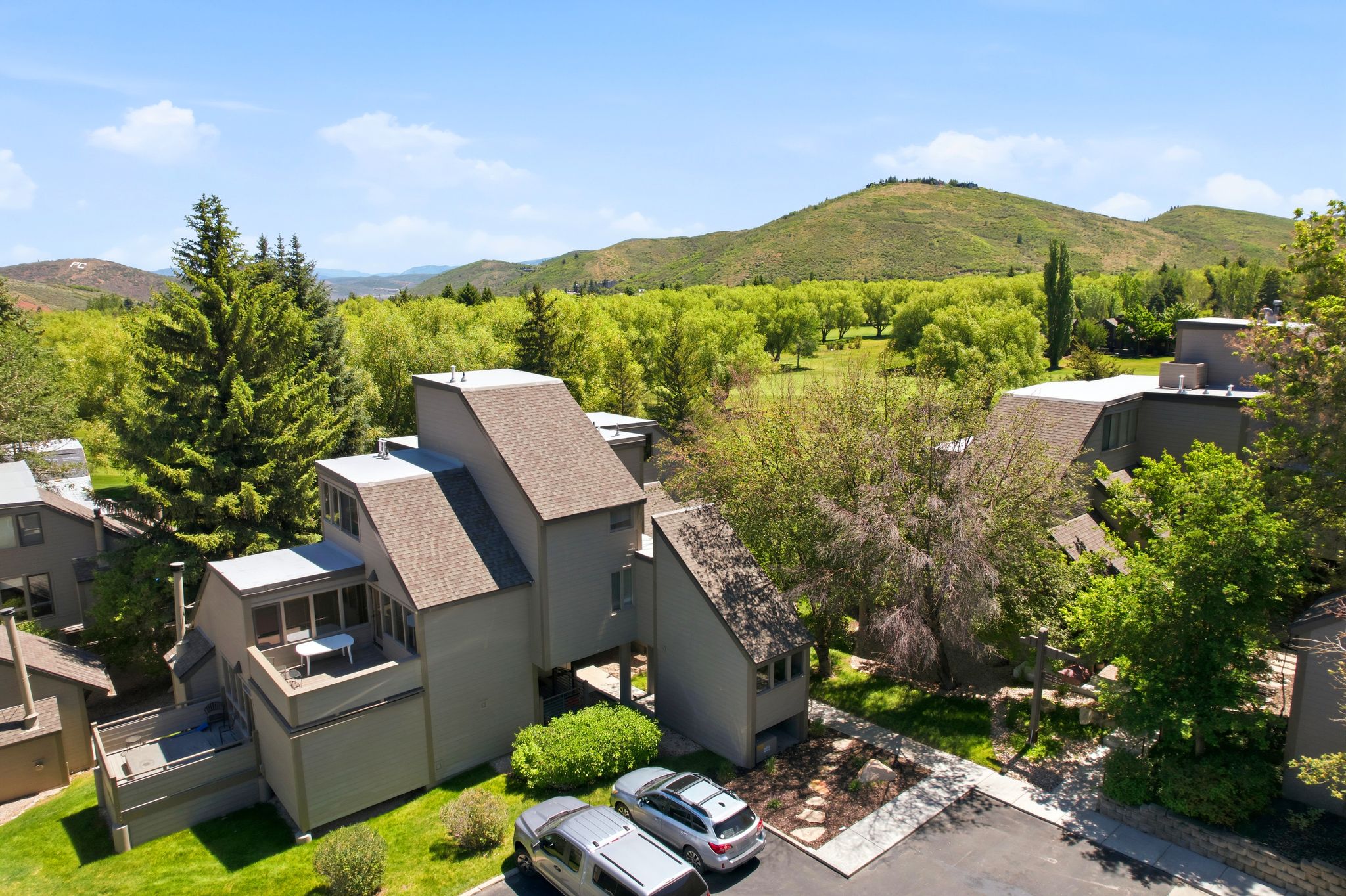 Contemporary multi-level residence featuring a pitched roofline and neutral-toned exterior