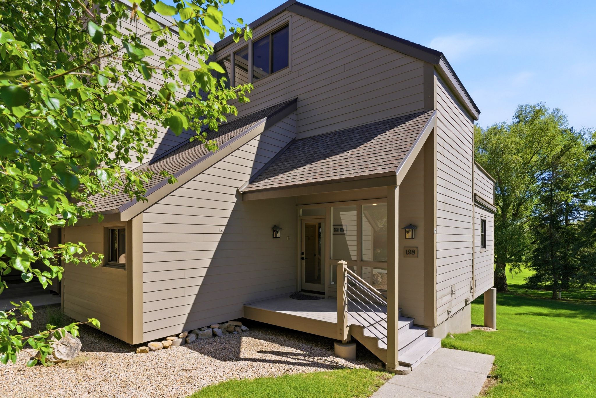 Multi-level property exterior featuring horizontal siding and a covered entry