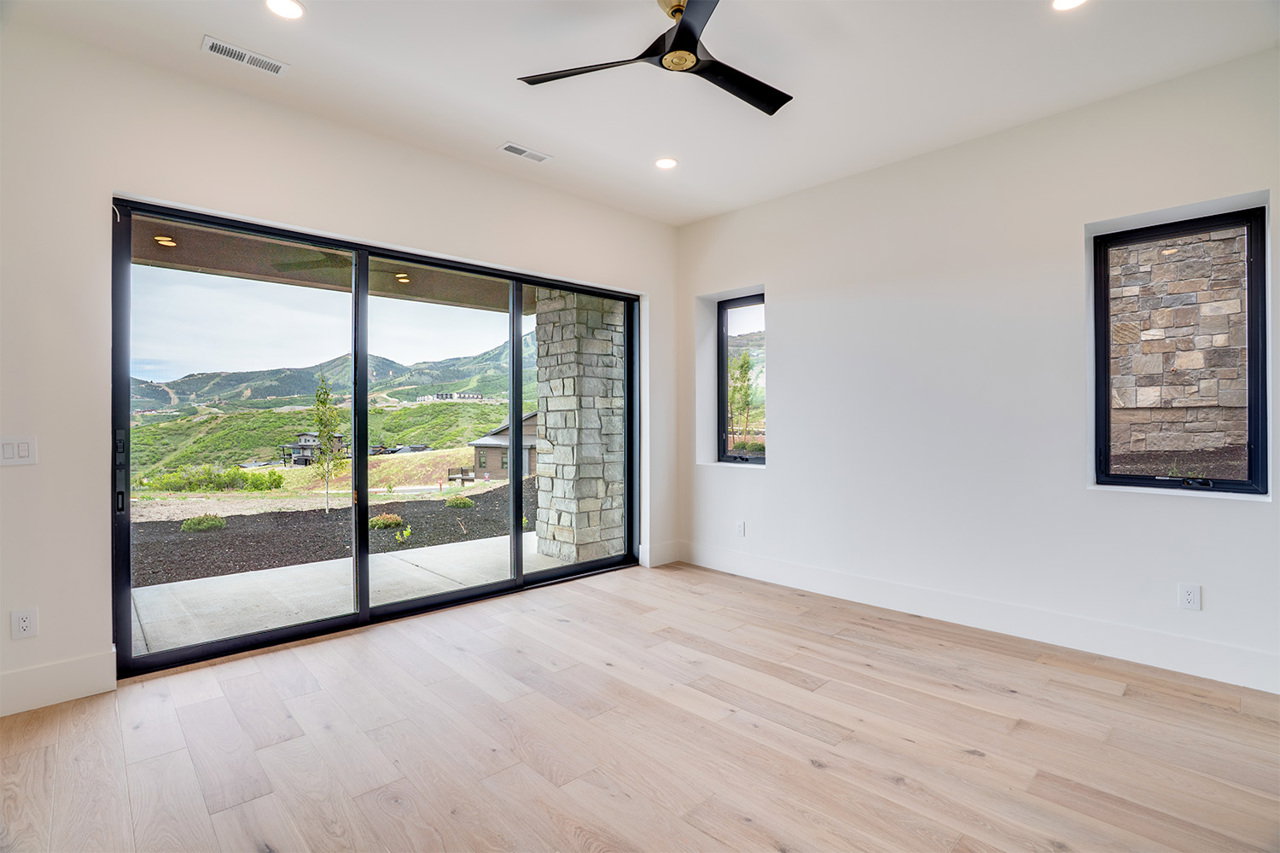 Bright interior featuring wood-finish flooring, recessed lighting, and a black ceiling fan