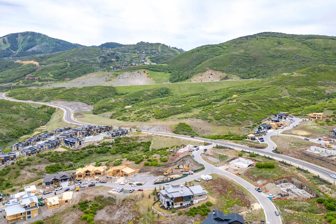 Expansive mountainous terrain featuring established roadways and new construction