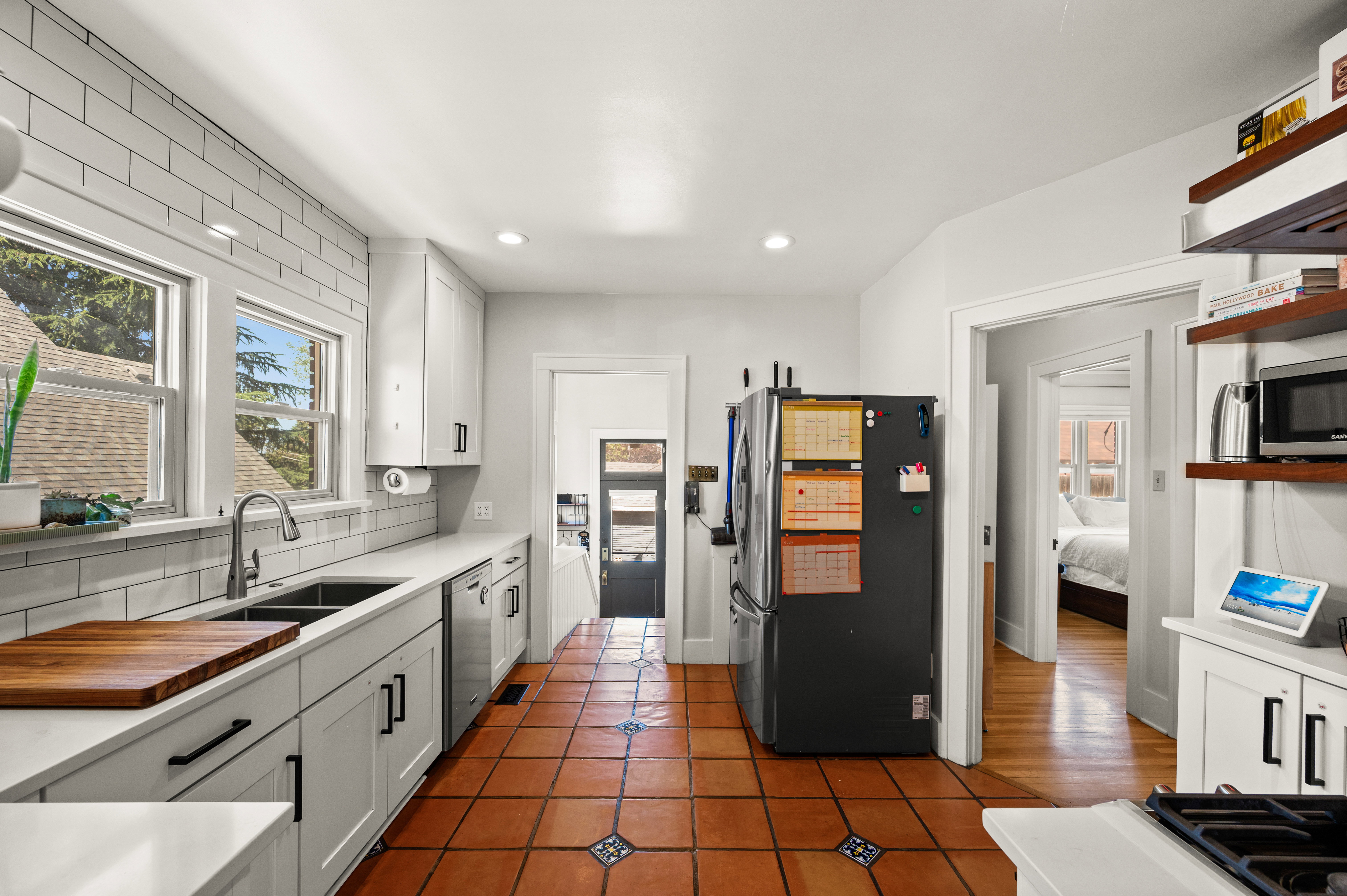 Kitchen featuring terracotta-style tile flooring with decorative accents