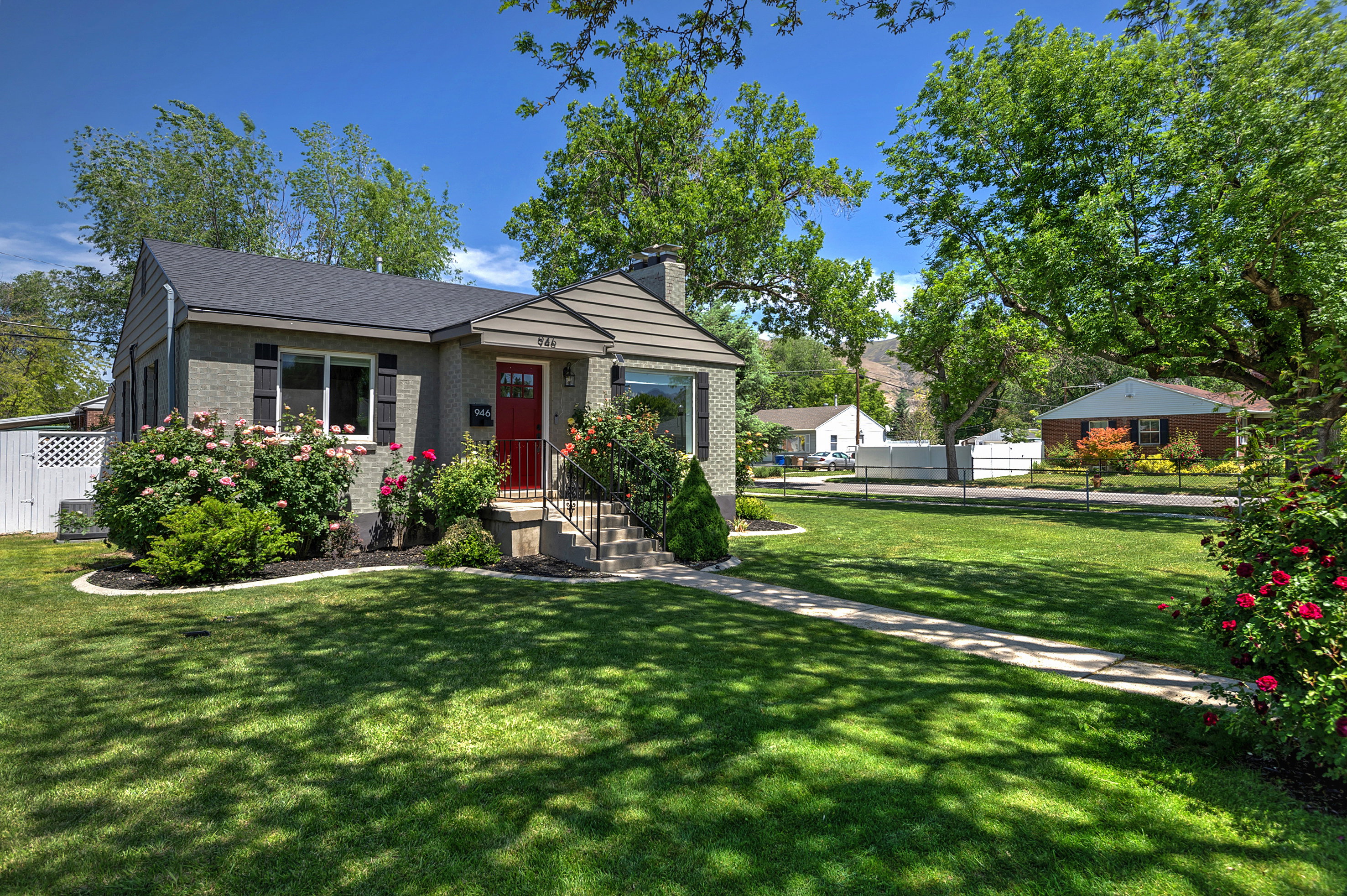 Charming single-story residence featuring a brick exterior and a contrasting red entry door