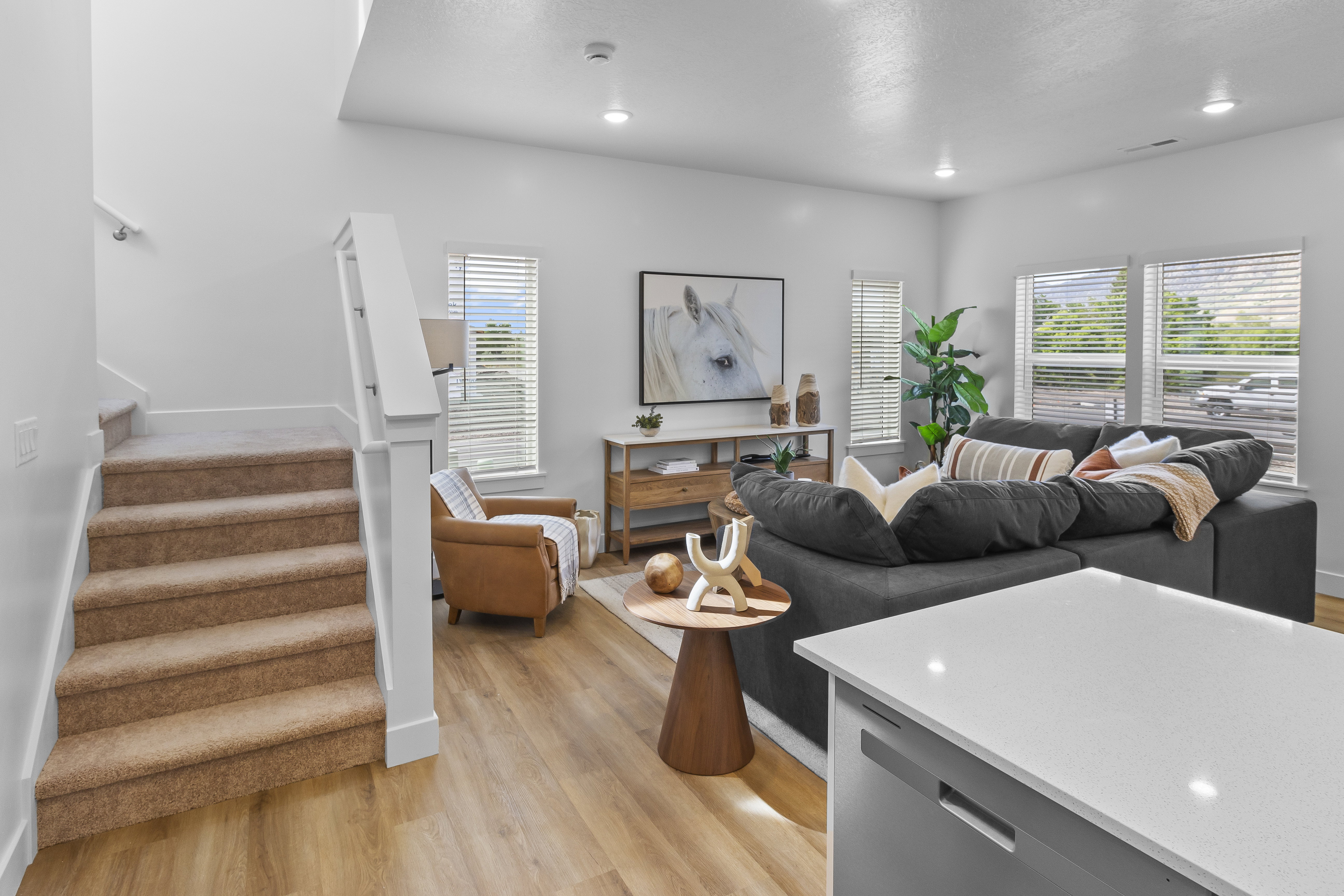 Open concept living area with wood-finish flooring