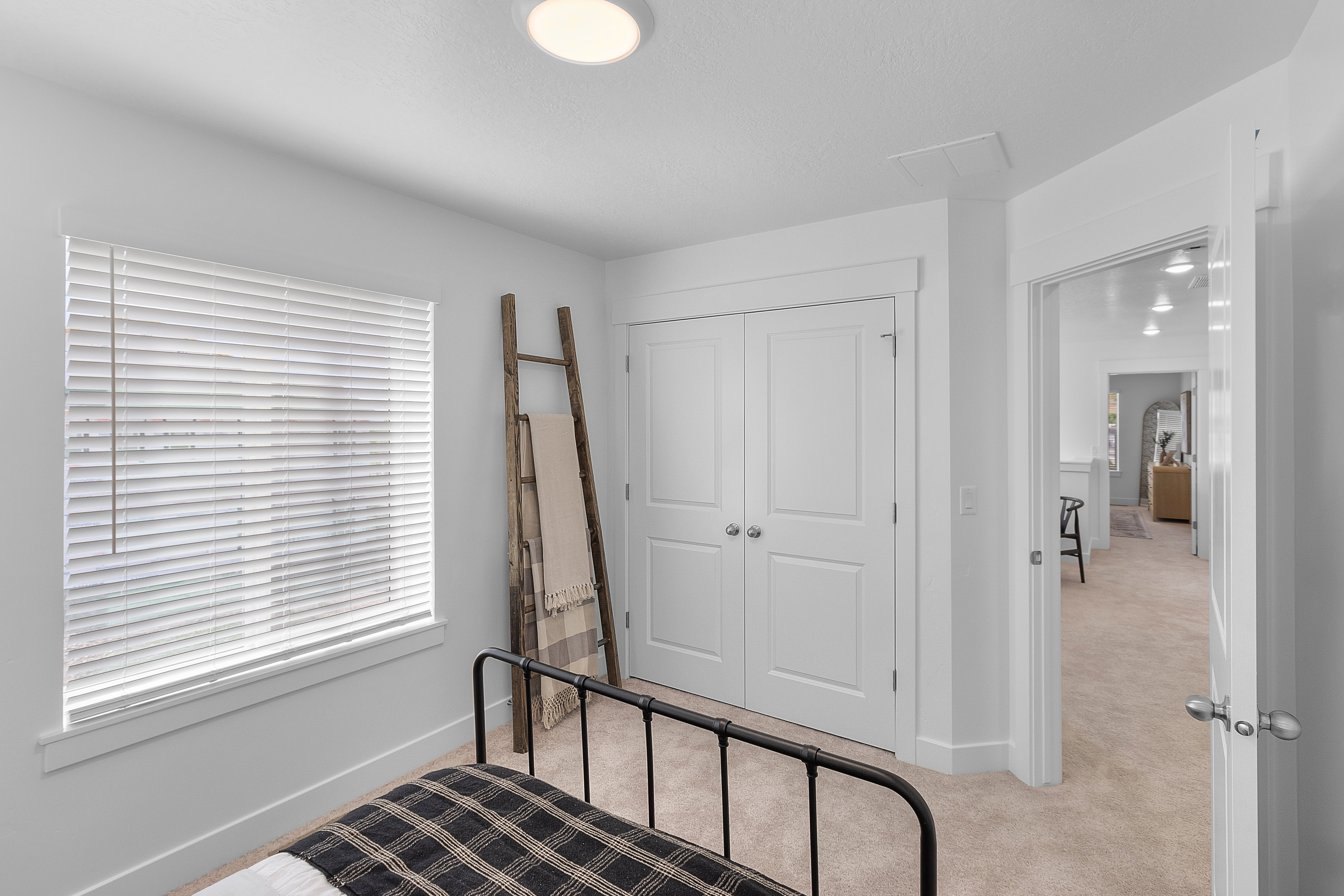 White-painted walls with neutral carpet flooring