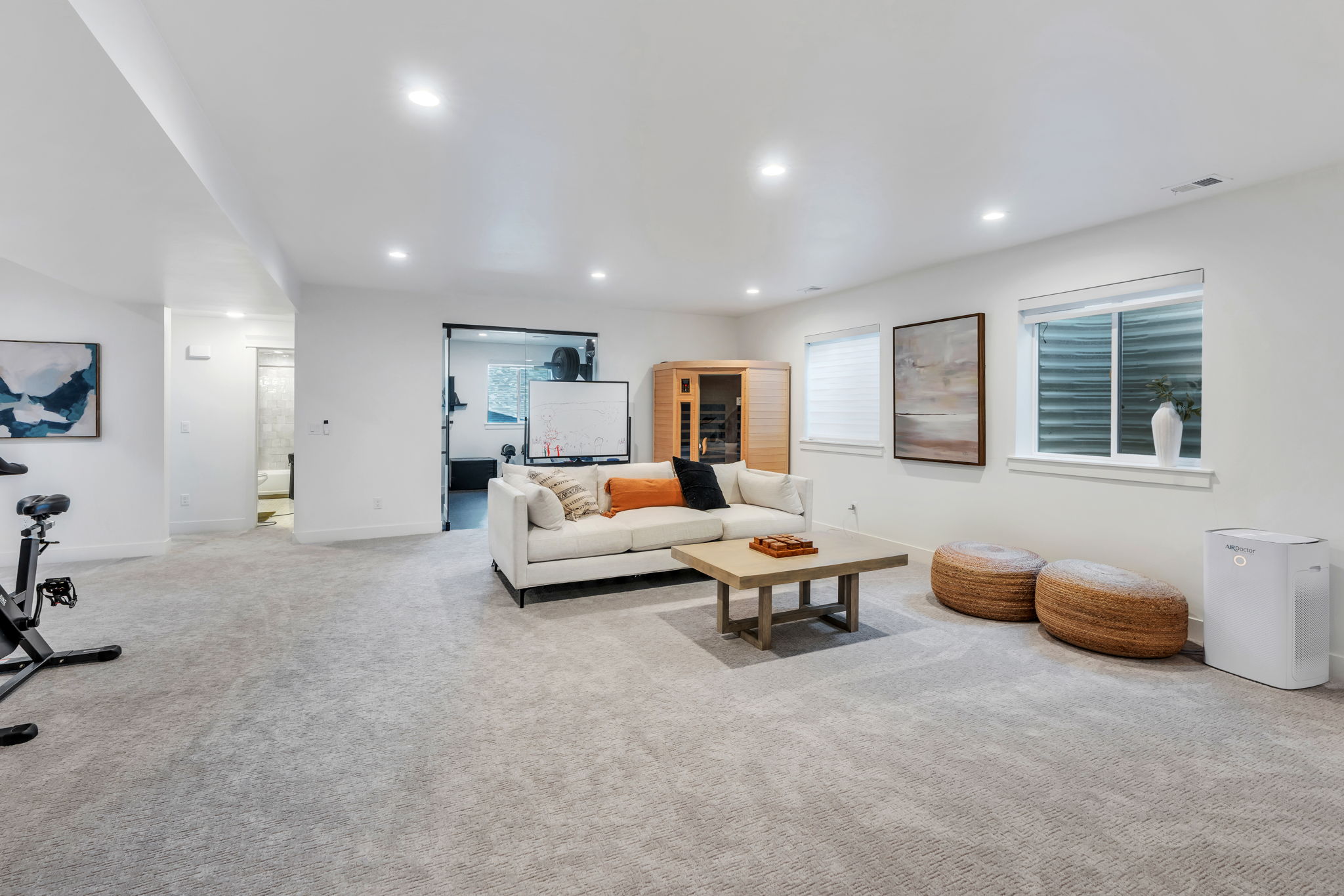 Spacious room featuring light gray carpet flooring, recessed lighting, and white walls