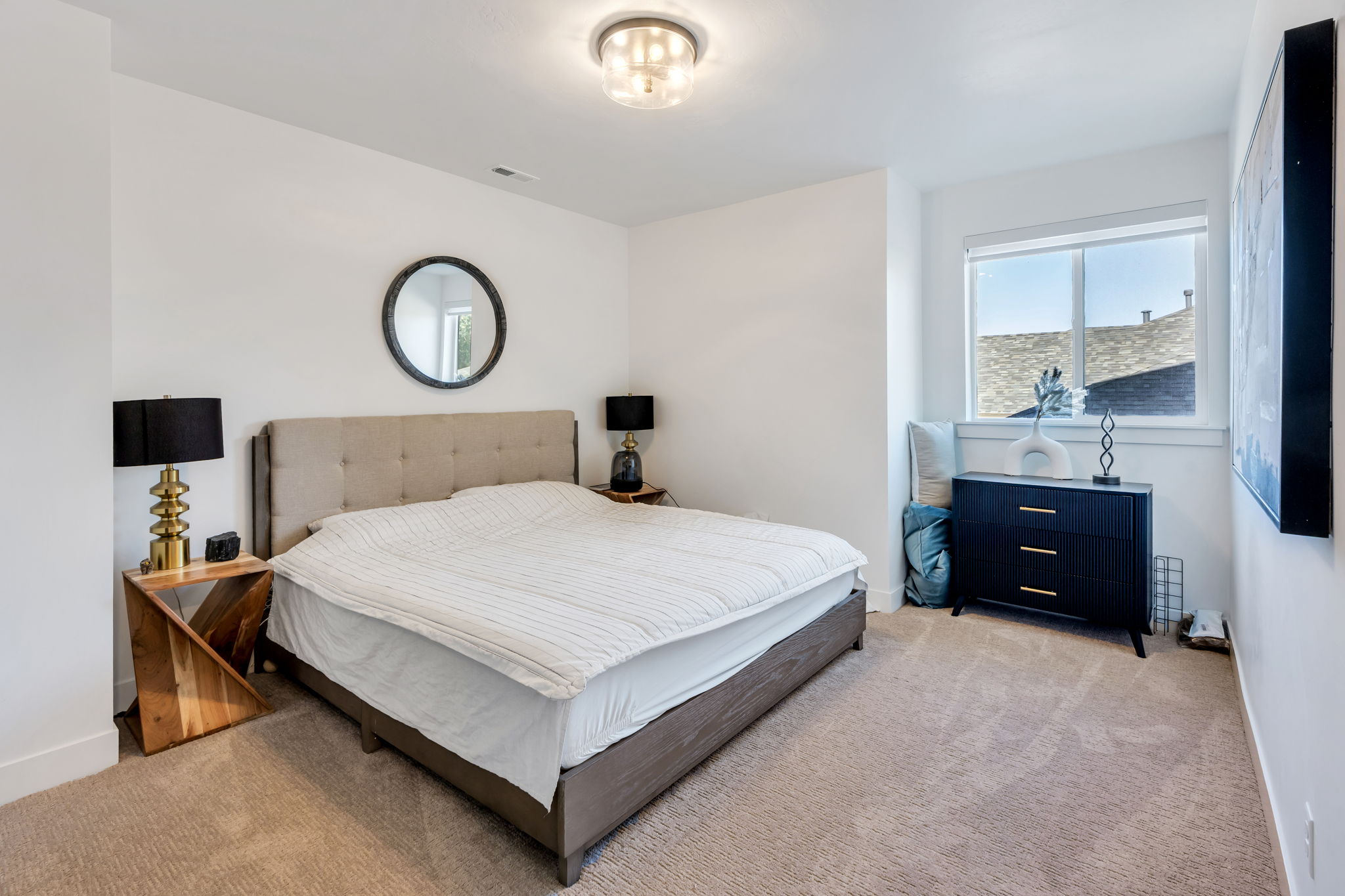 Carpeted room featuring a window, built-in light fixture, and white wall finishes