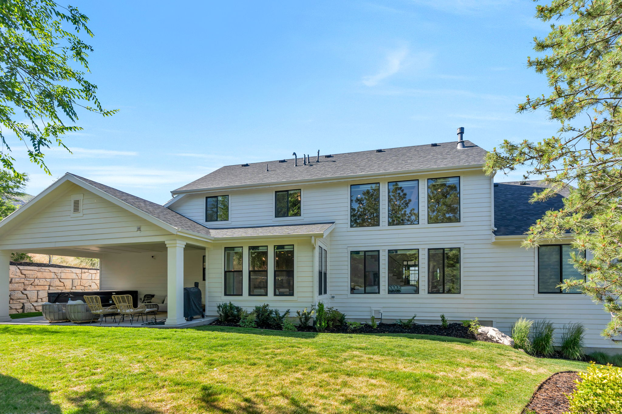 White siding exterior with multiple large windows