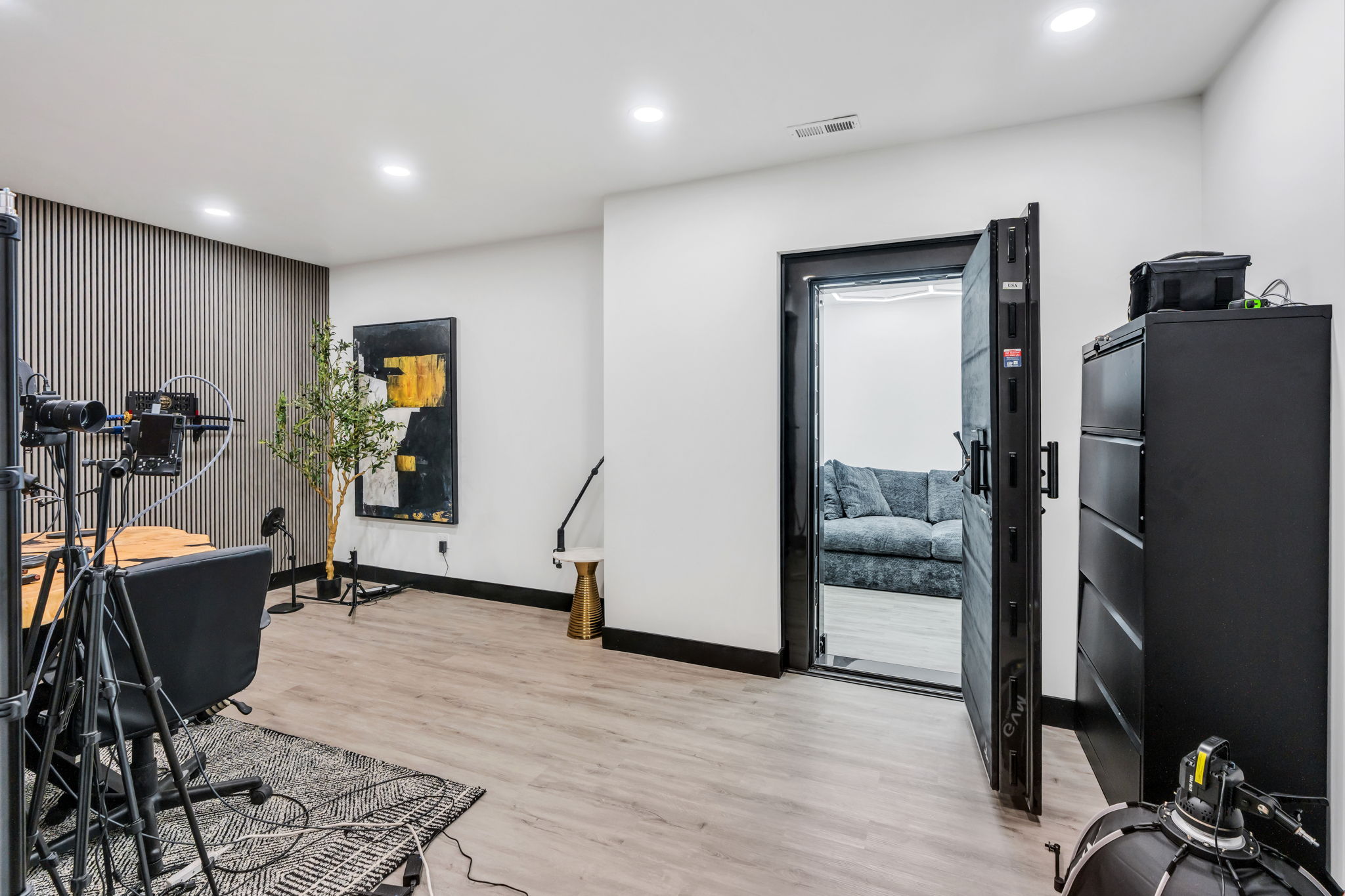 Spacious room featuring wood-finish flooring, recessed lighting, and a textured accent wall