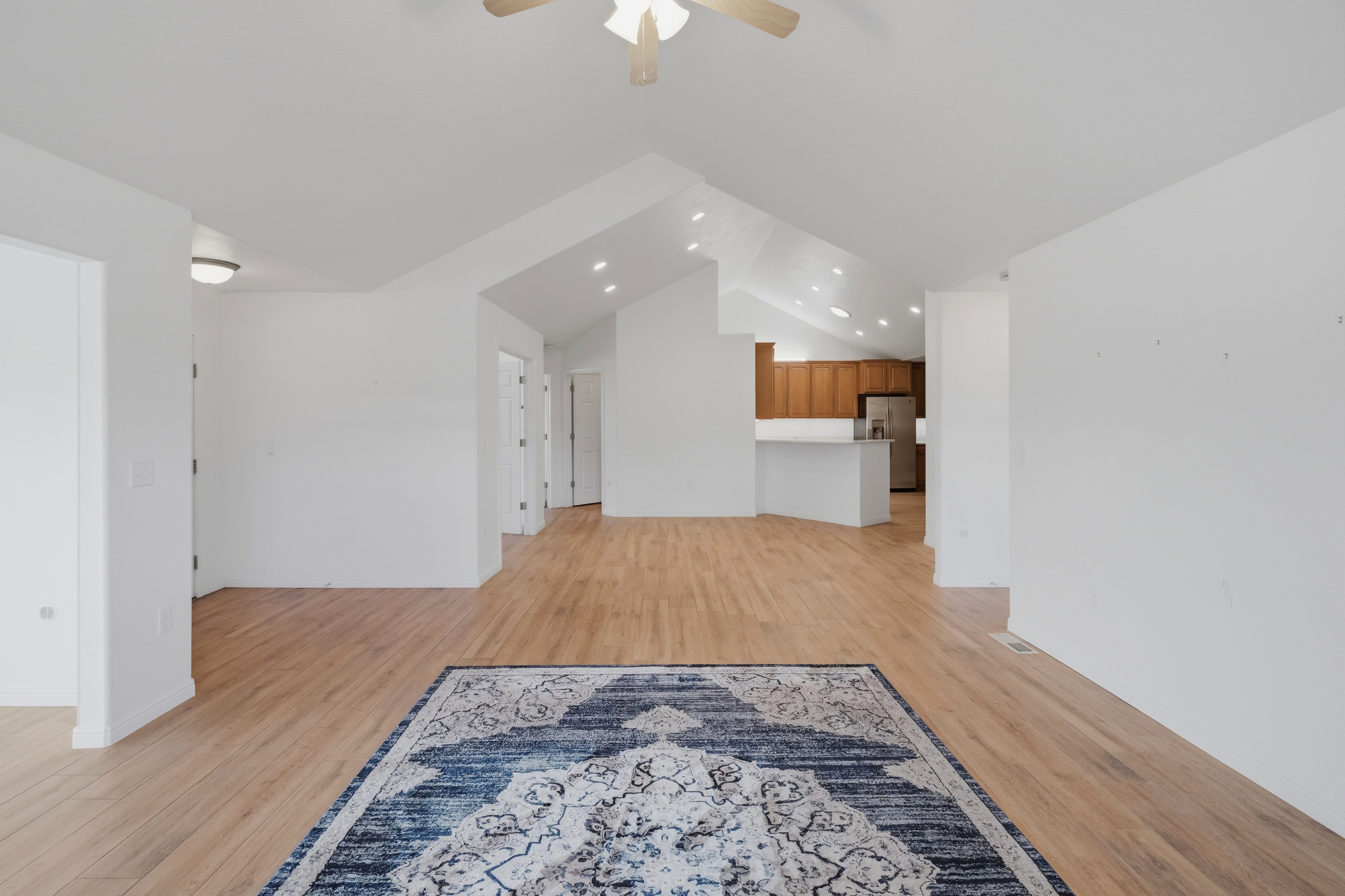 Spacious interior with high vaulted ceilings and wood-finish flooring