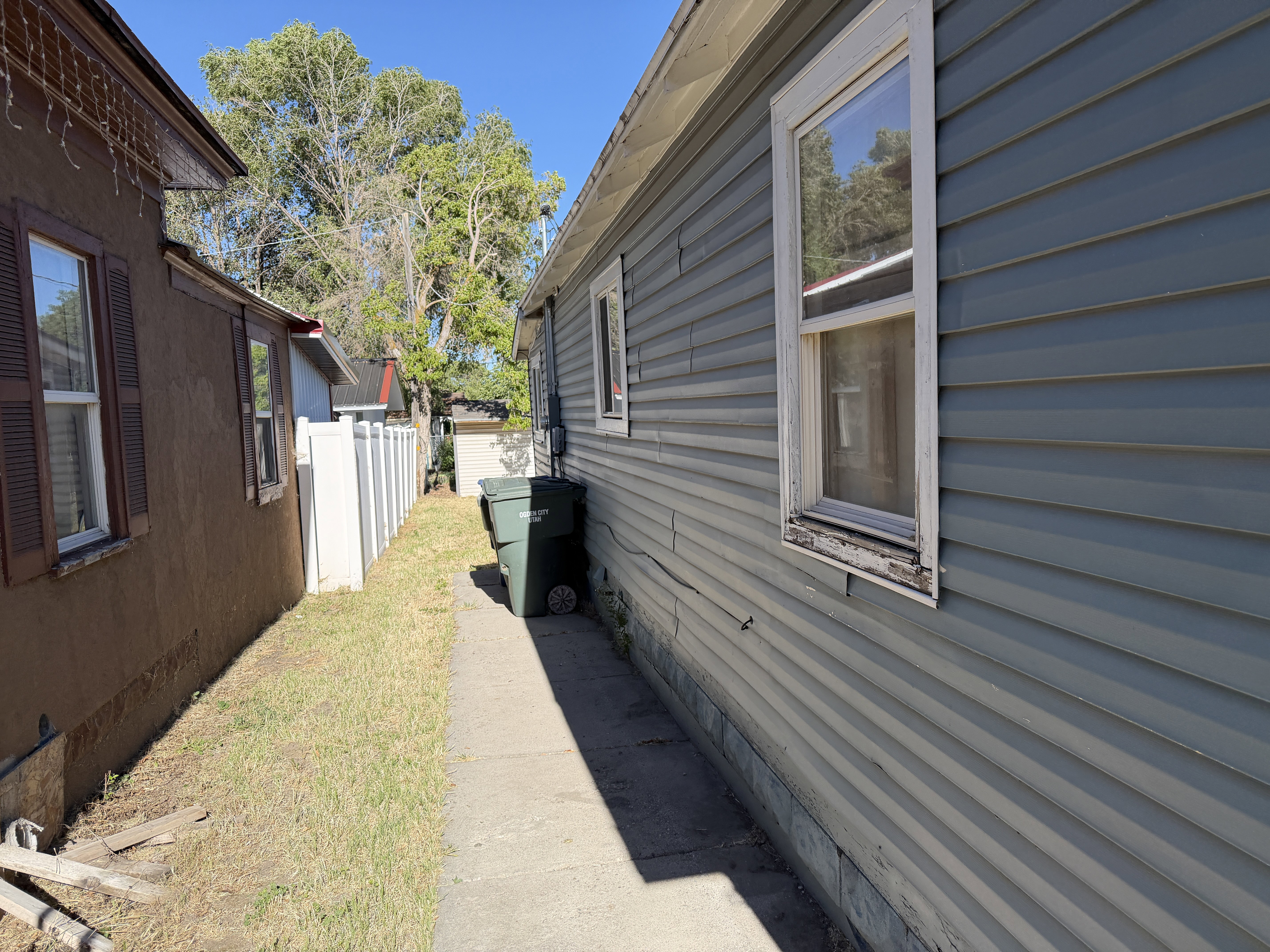 Exterior siding in a light blue finish, featuring a single-hung window with white trim