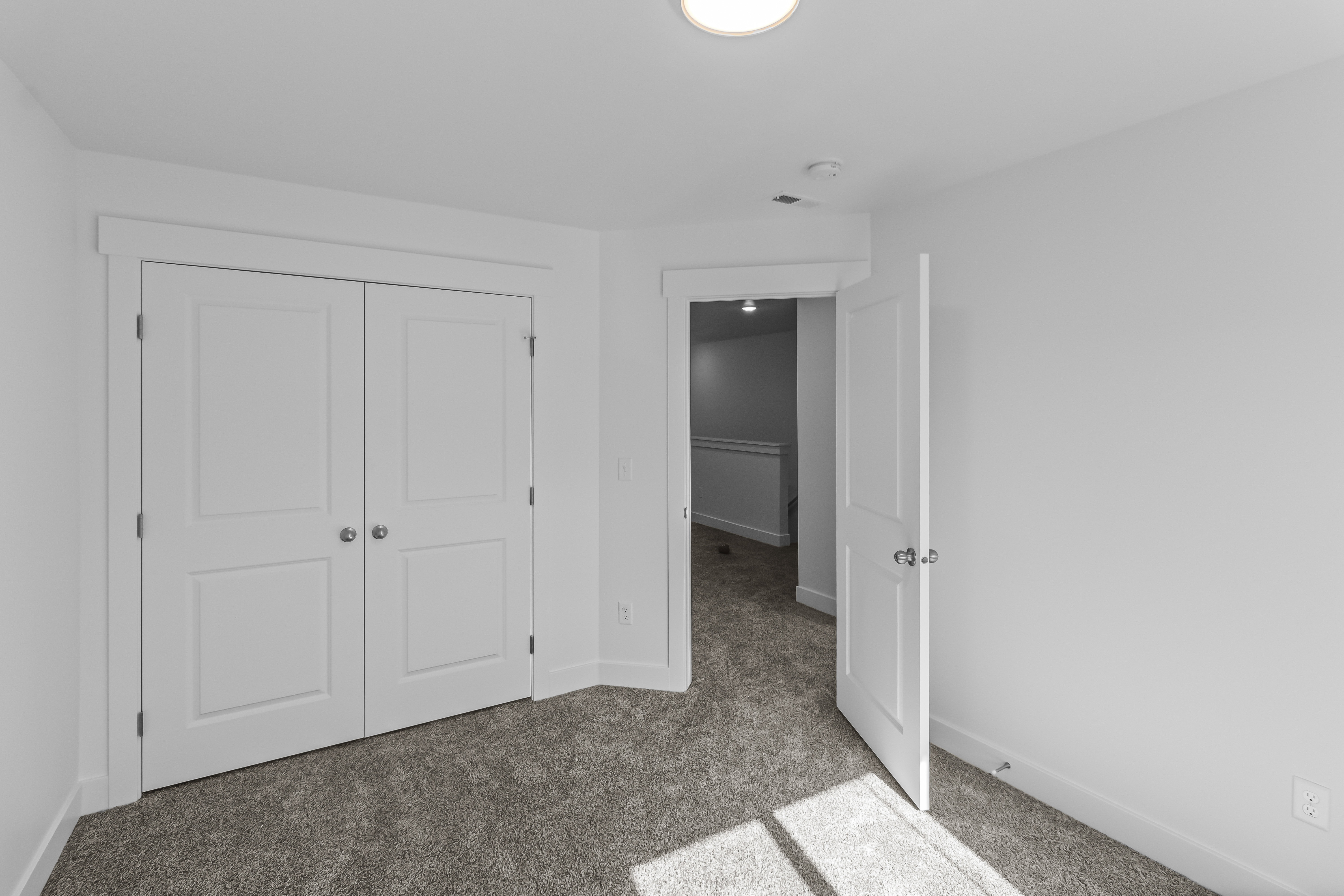 Neutral wall finishes, plush carpeting, double-panel closet doors, and recessed lighting