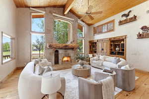 Stone fireplace with a log mantel and integrated hearth