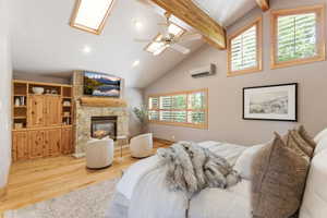 Vaulted ceiling with exposed wood beams and skylights