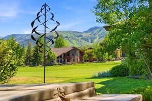 Expansive green lawn with mountain backdrop