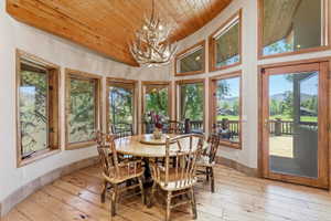 Curved wall of large windows with wood framing