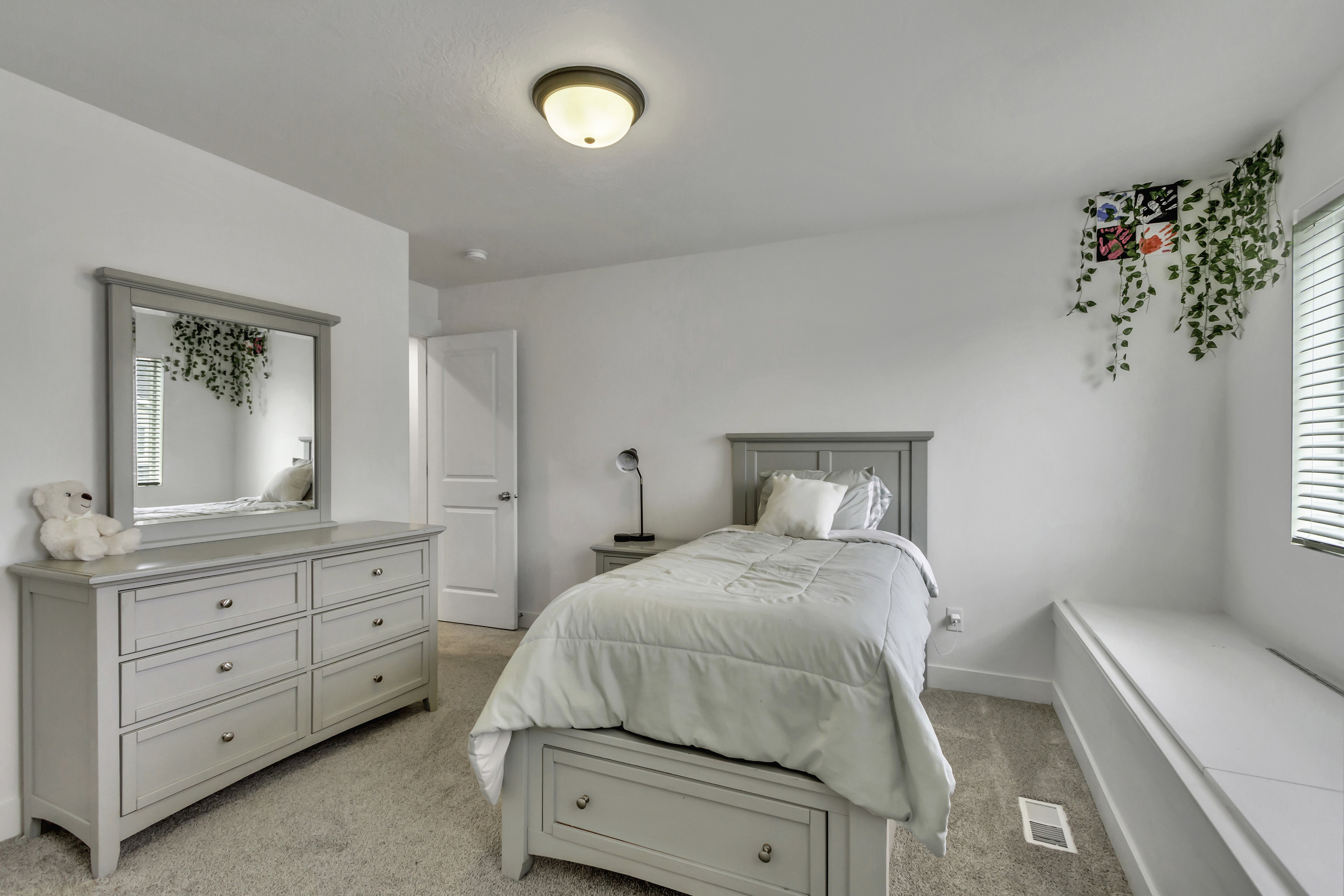 Carpeted interior room featuring light-colored walls and a ceiling-mounted light fixture