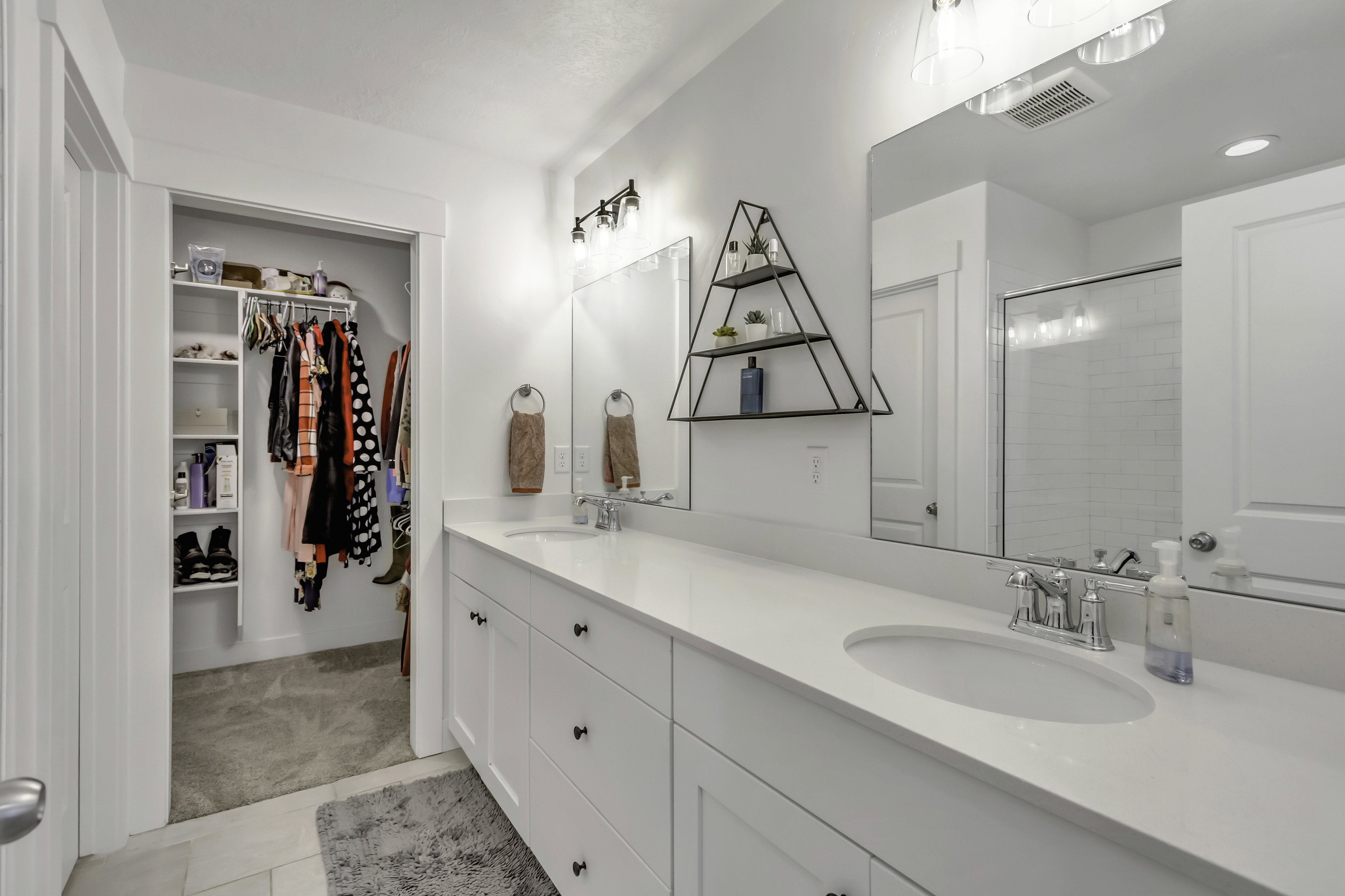 Double vanity with integrated sinks, chrome fixtures, and a spacious countertop